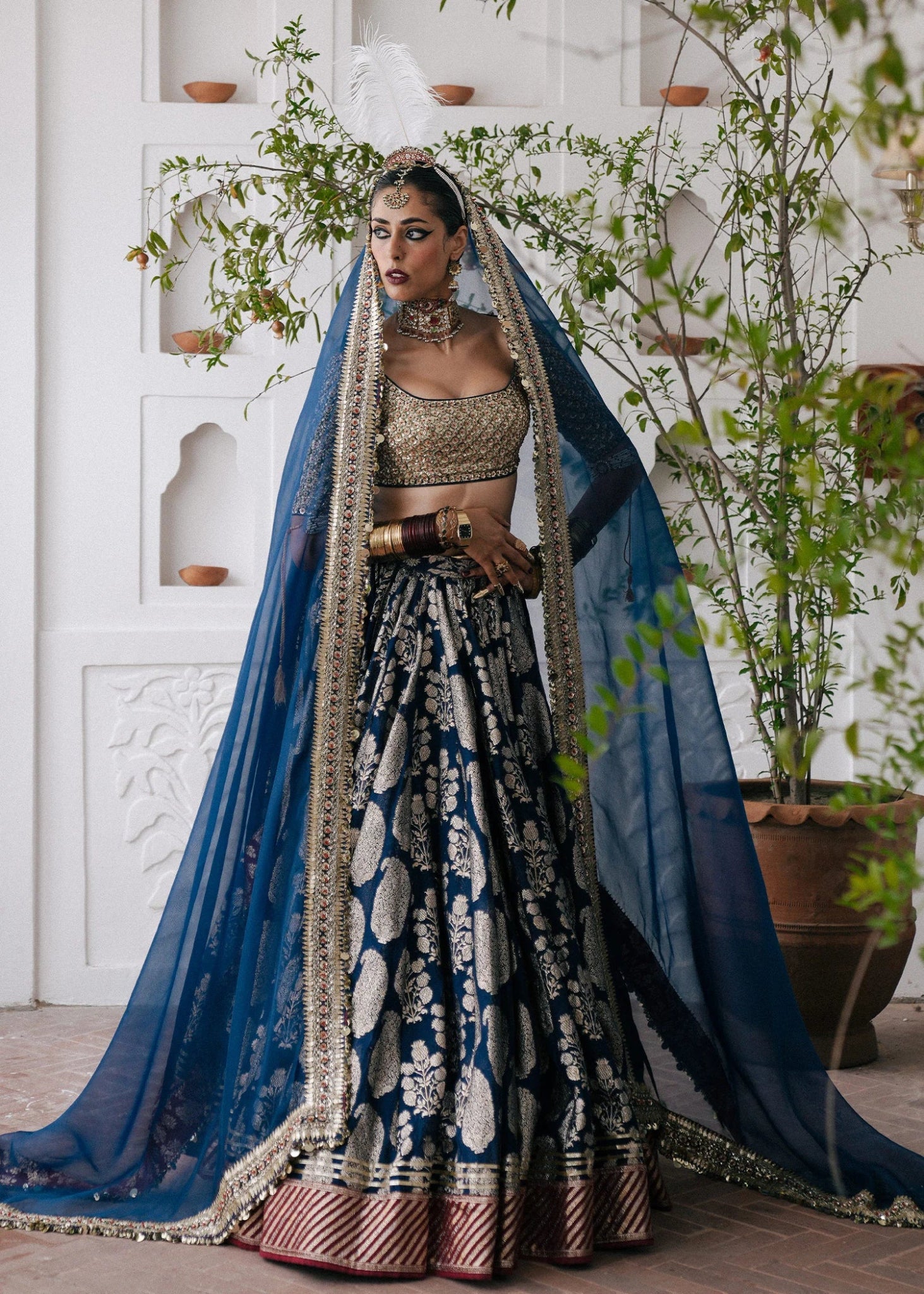 Hussain Rehar's Neelam lehenga, choli and duppatta from Rehar Nagar Bridals'24 in rich blue with intricate silver embroidery, perfect for luxury bridal wear. Available online in the UK, ideal for formal Pakistani bridal attire.