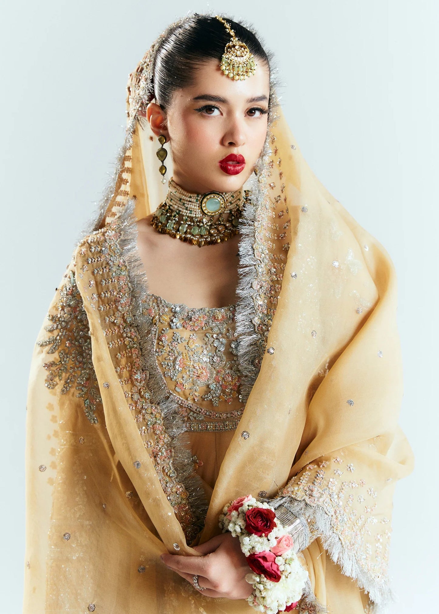 Model wearing a golden Hussain Rehar Aether dress from the Sitaray Formals collection, embellished with intricate silver embroidery.