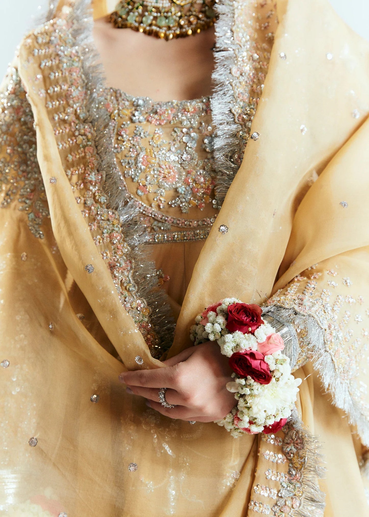 Model wearing a golden Hussain Rehar Aether dress from the Sitaray Formals collection, embellished with intricate silver embroidery.