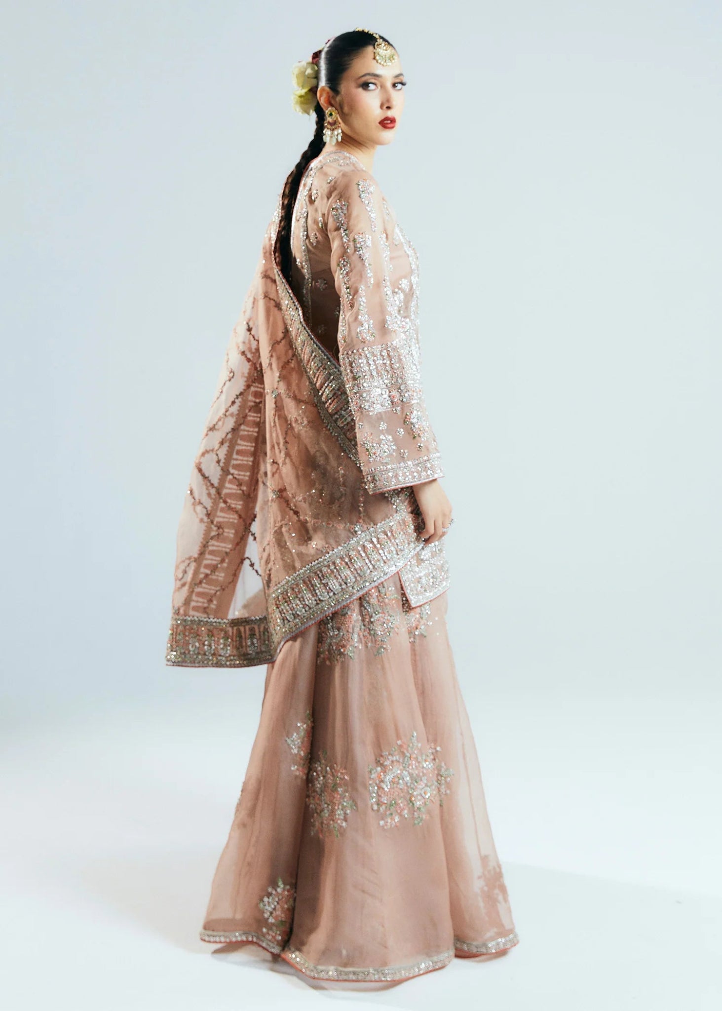 Model wearing a beige Dune dress from Hussain Rehar's Sitaray Formals collection. The dress features intricate embroidery and embellishments, perfect for wedding attire. Available for Pakistani clothes online in the UK.