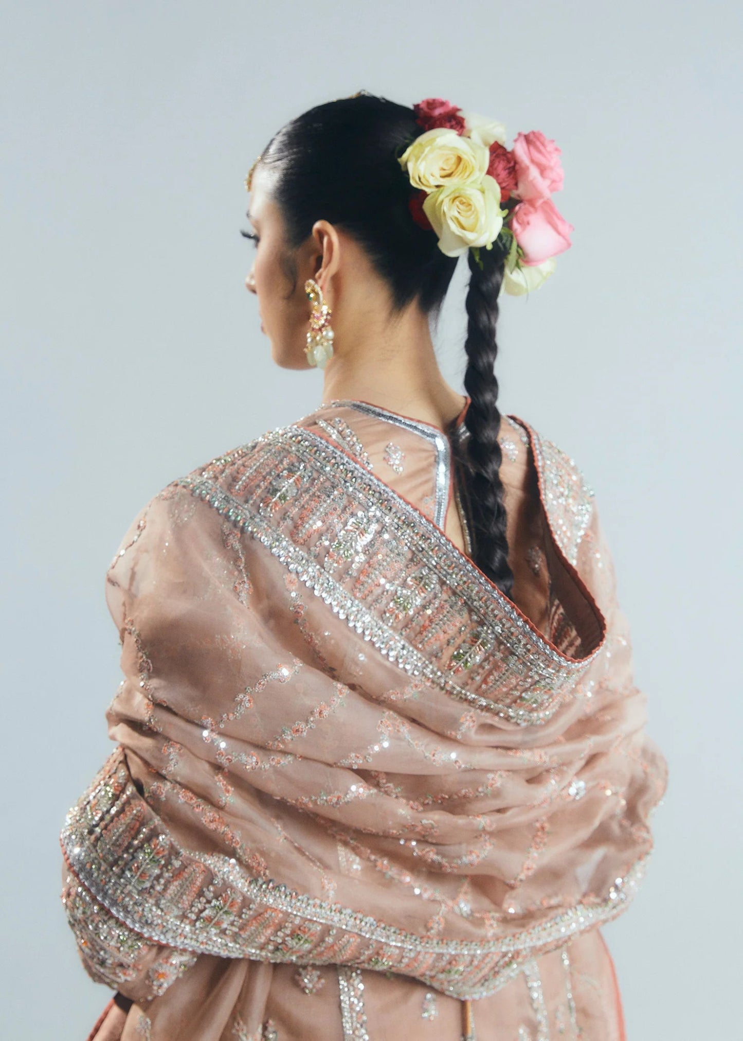 Model wearing a beige Dune dress from Hussain Rehar's Sitaray Formals collection. The dress features intricate embroidery and embellishments, perfect for wedding attire. Available for Pakistani clothes online in the UK.