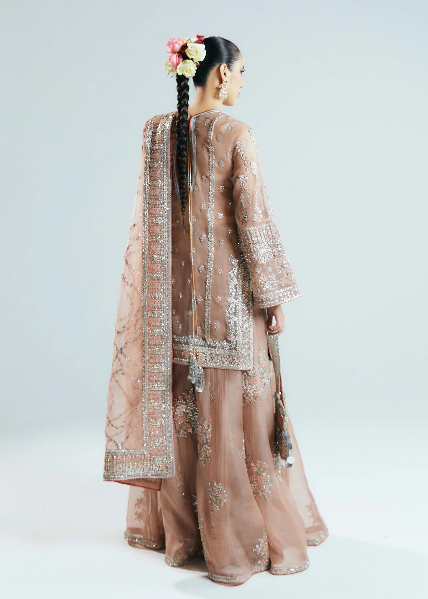 Model wearing a beige Dune dress from Hussain Rehar's Sitaray Formals collection. The dress features intricate embroidery and embellishments, perfect for wedding attire. Available for Pakistani clothes online in the UK.