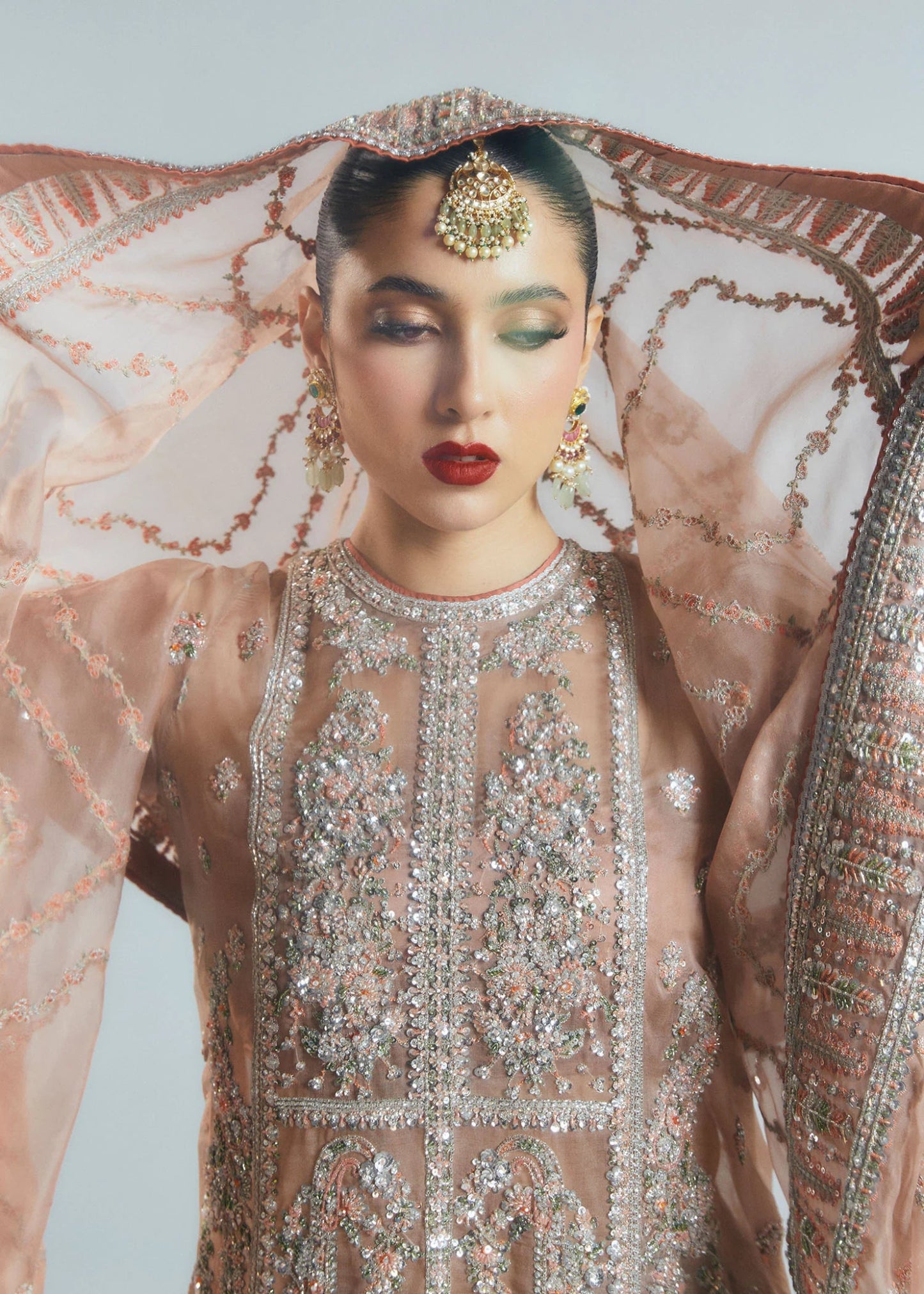 Model wearing a beige Dune dress from Hussain Rehar's Sitaray Formals collection. The dress features intricate embroidery and embellishments, perfect for wedding attire. Available for Pakistani clothes online in the UK.