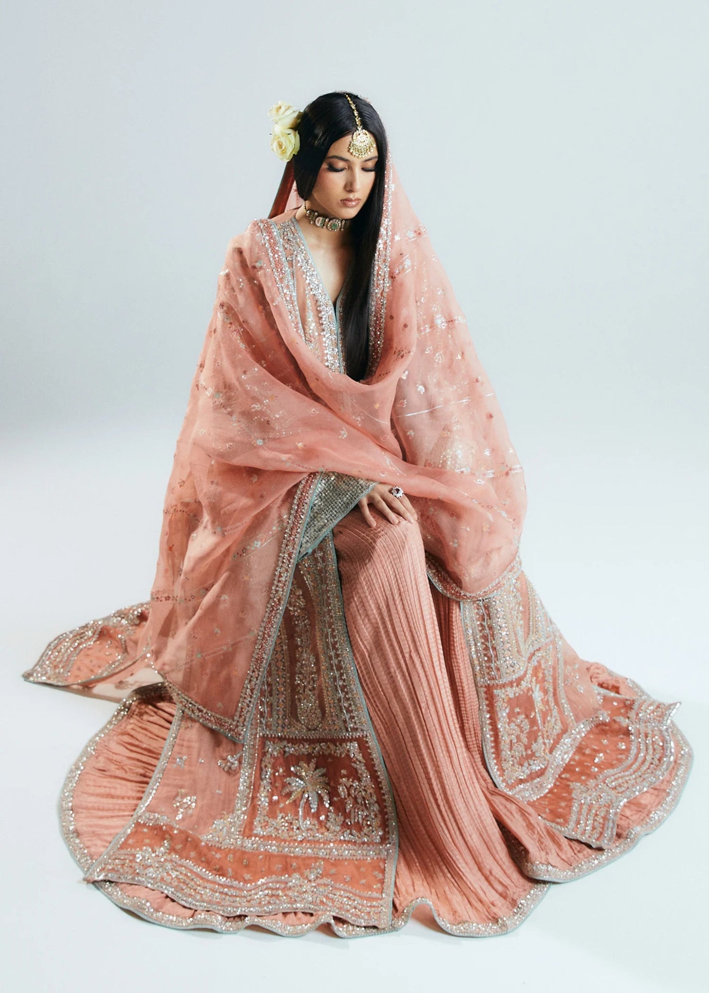 Model wearing a pink embellished Dusk dress from Hussain Rehar's Sitaray Formals collection. Perfect for Pakistani wedding clothes online in UK.