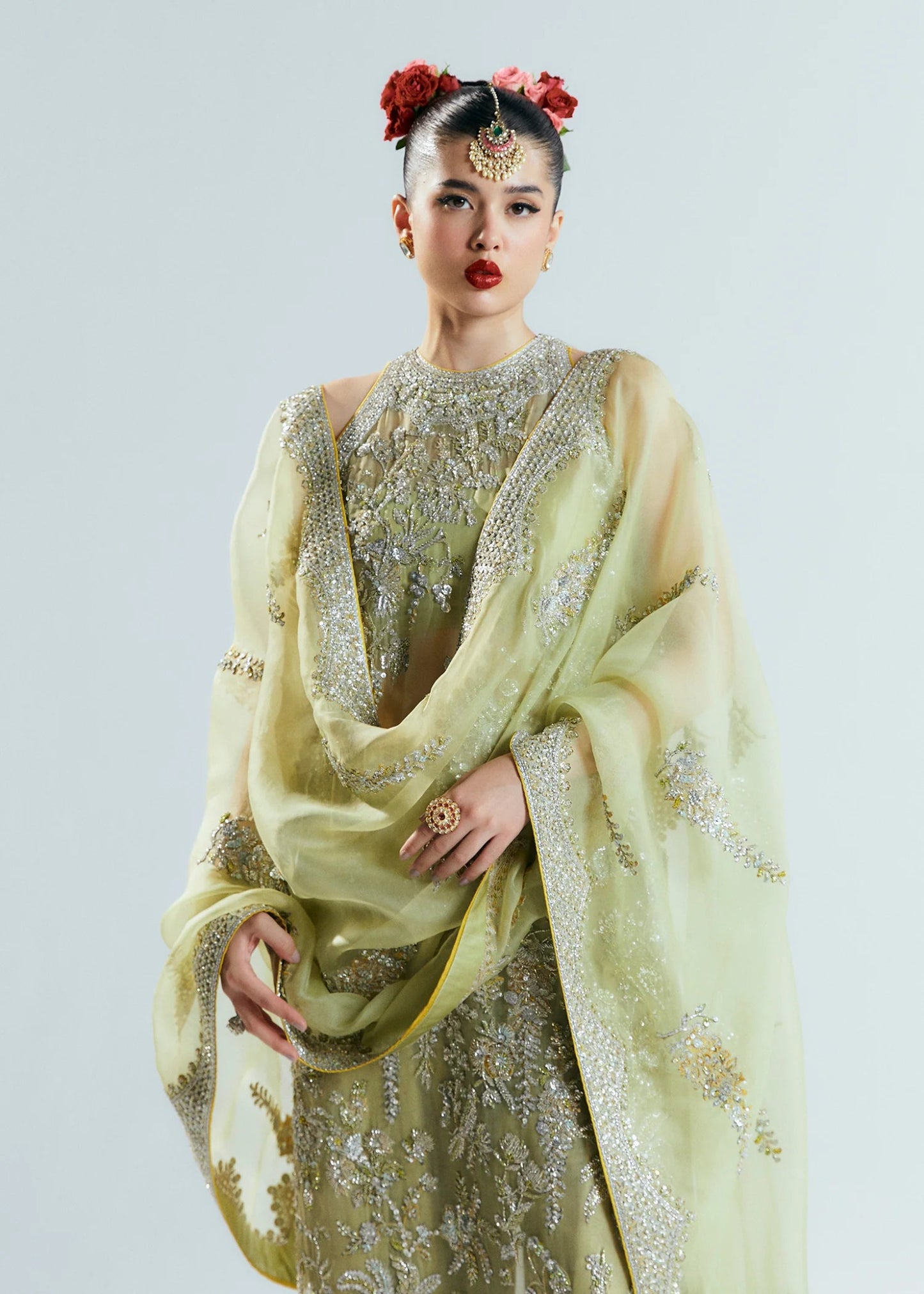 Model wearing a pastel green Mintara dress by Hussain Rehar, featuring intricate silver embroidery, perfect for weddings. Pakistani clothes online UK.