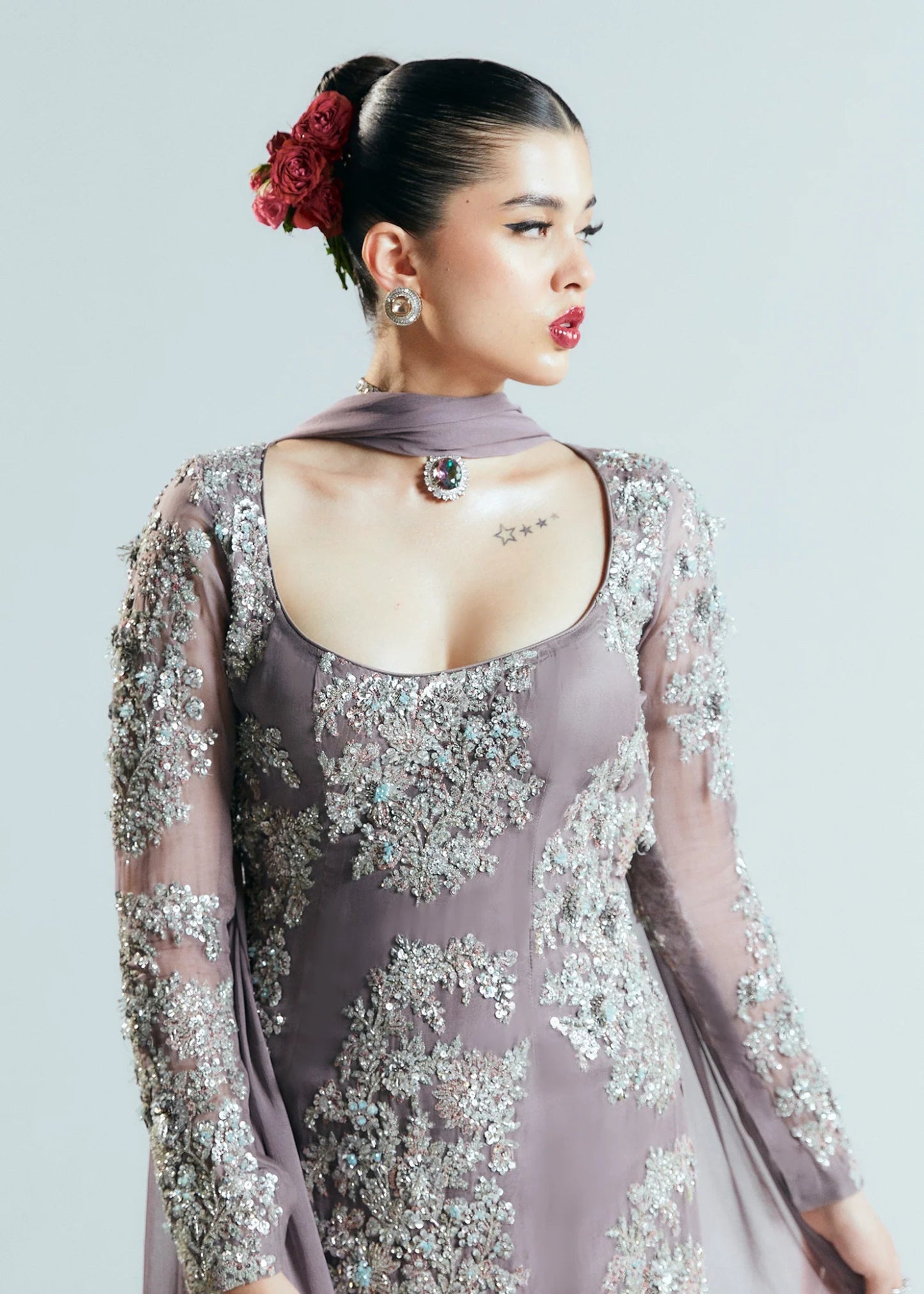 Model wearing a shimmering, mauve - colored Mystic dress from Hussain Rehar's Sitaray Formals collection.