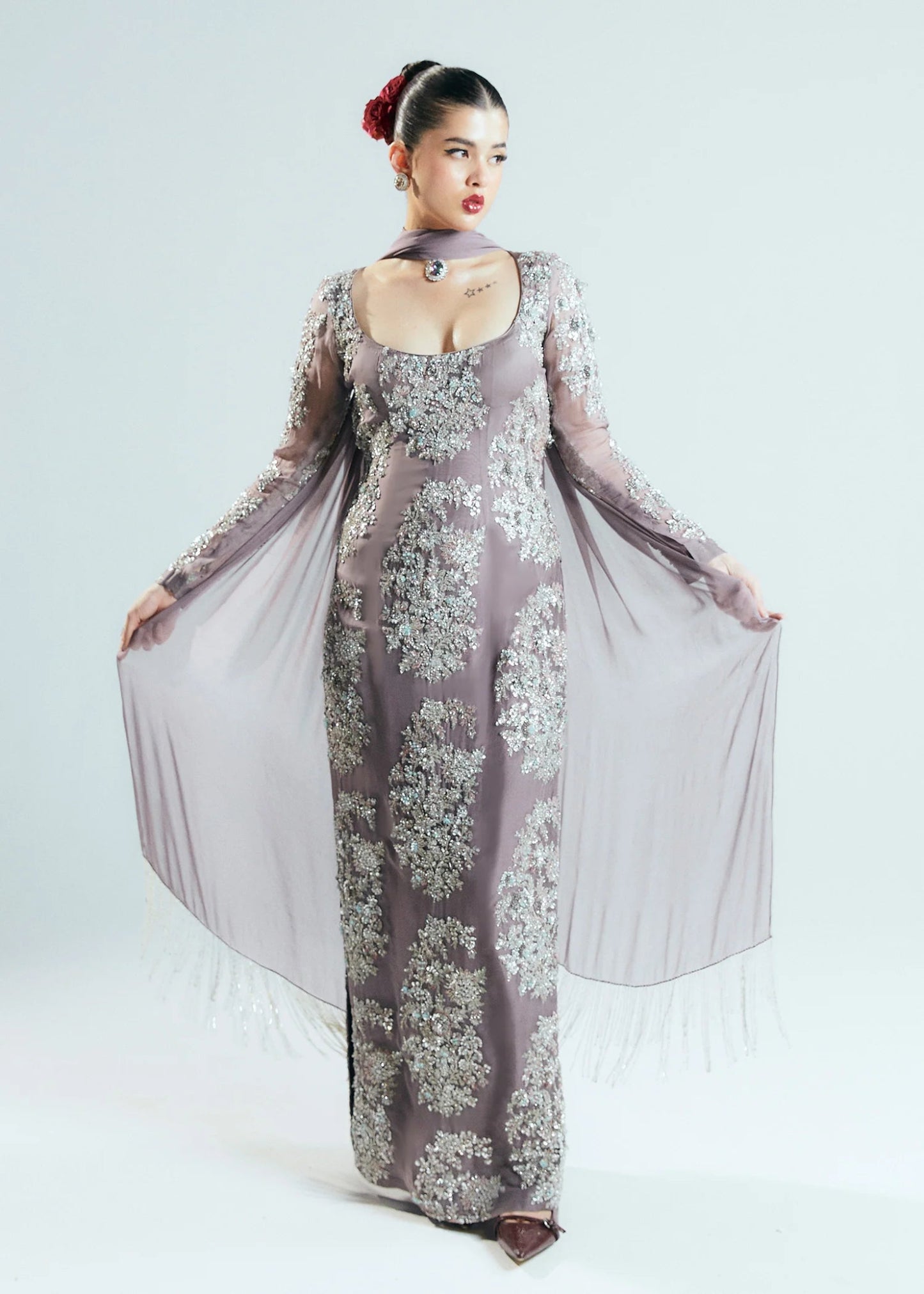 Model wearing a shimmering, mauve - colored Mystic dress from Hussain Rehar's Sitaray Formals collection.