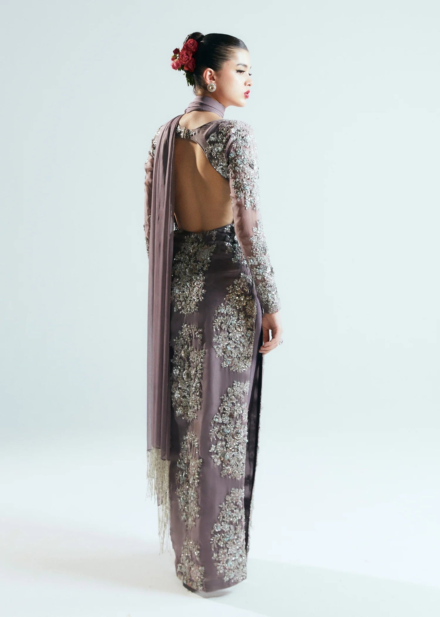 Model wearing a shimmering, mauve - colored Mystic dress from Hussain Rehar's Sitaray Formals collection.