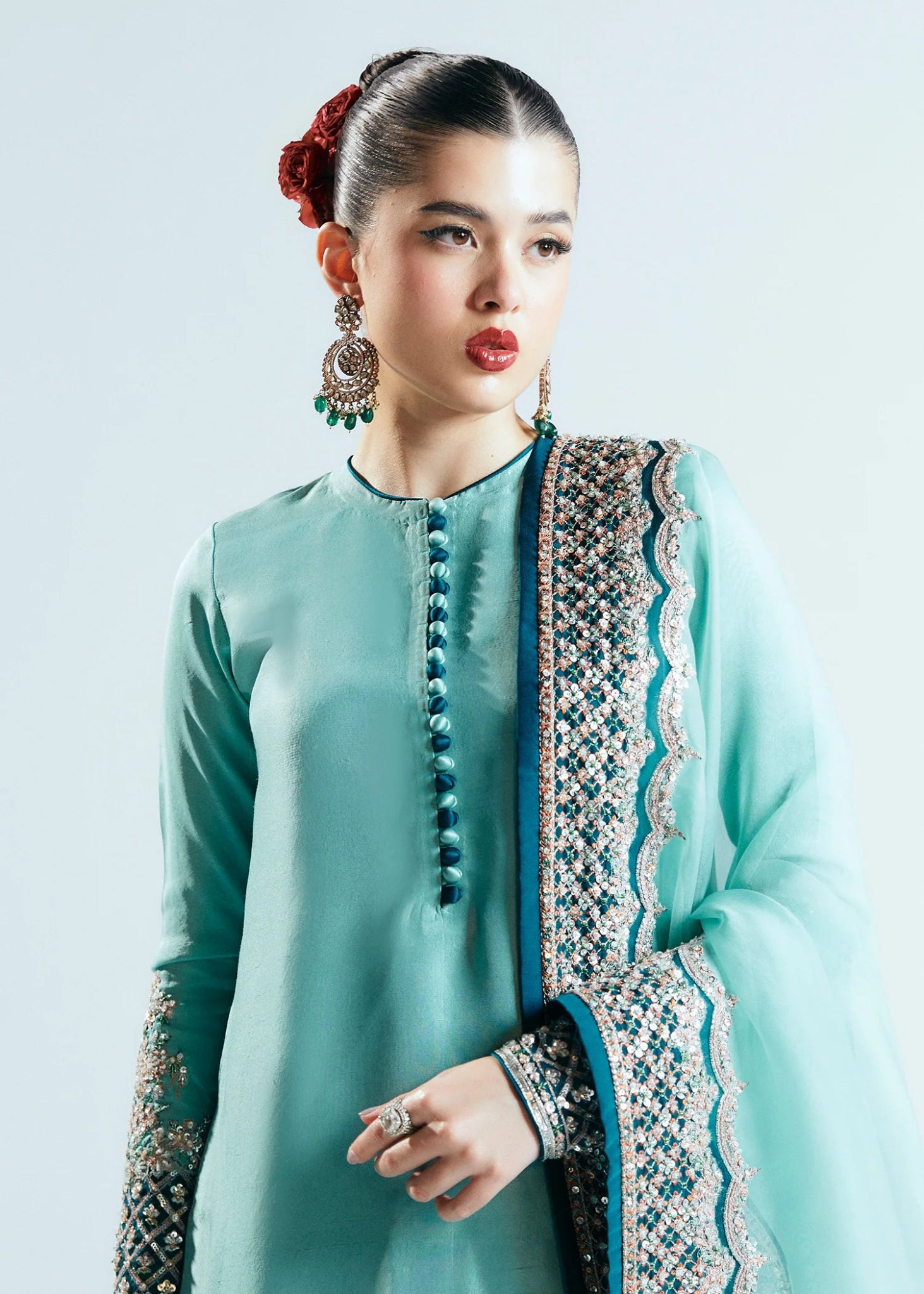 Model wearing a teal Hussain Rehar Reef dress with intricate embellishments from the Sitaray Formals collection. Perfect for weddings.