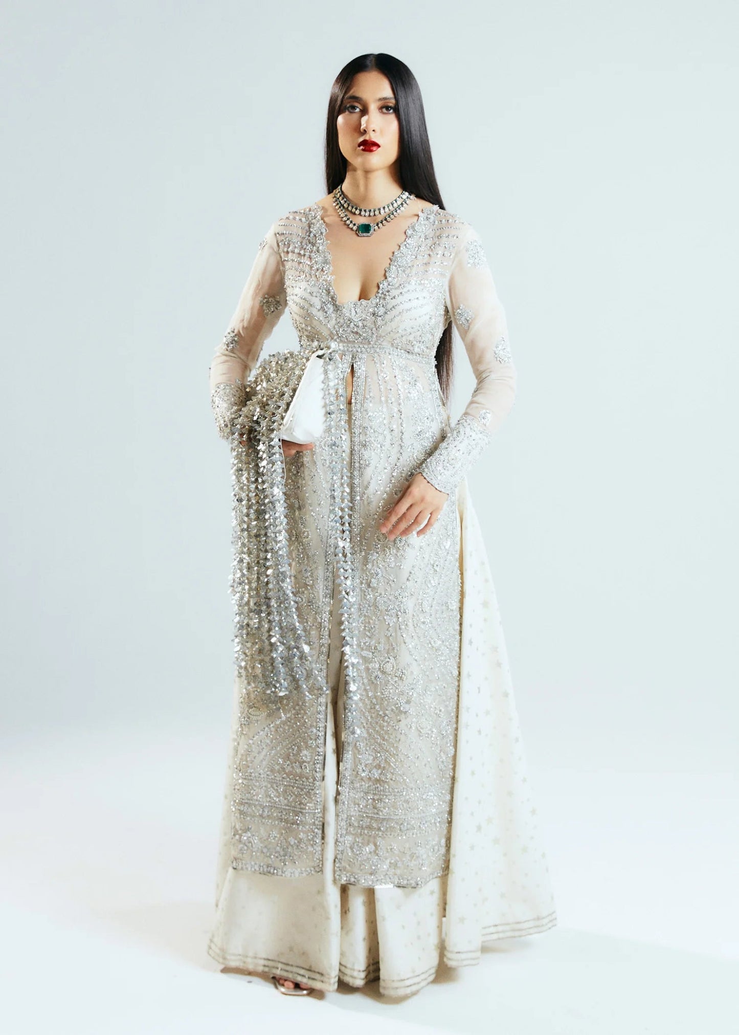 Model wearing a silver Hussain Rehar Seraph dress with intricate embellishments. Perfect for weddings, available in the UK online store.