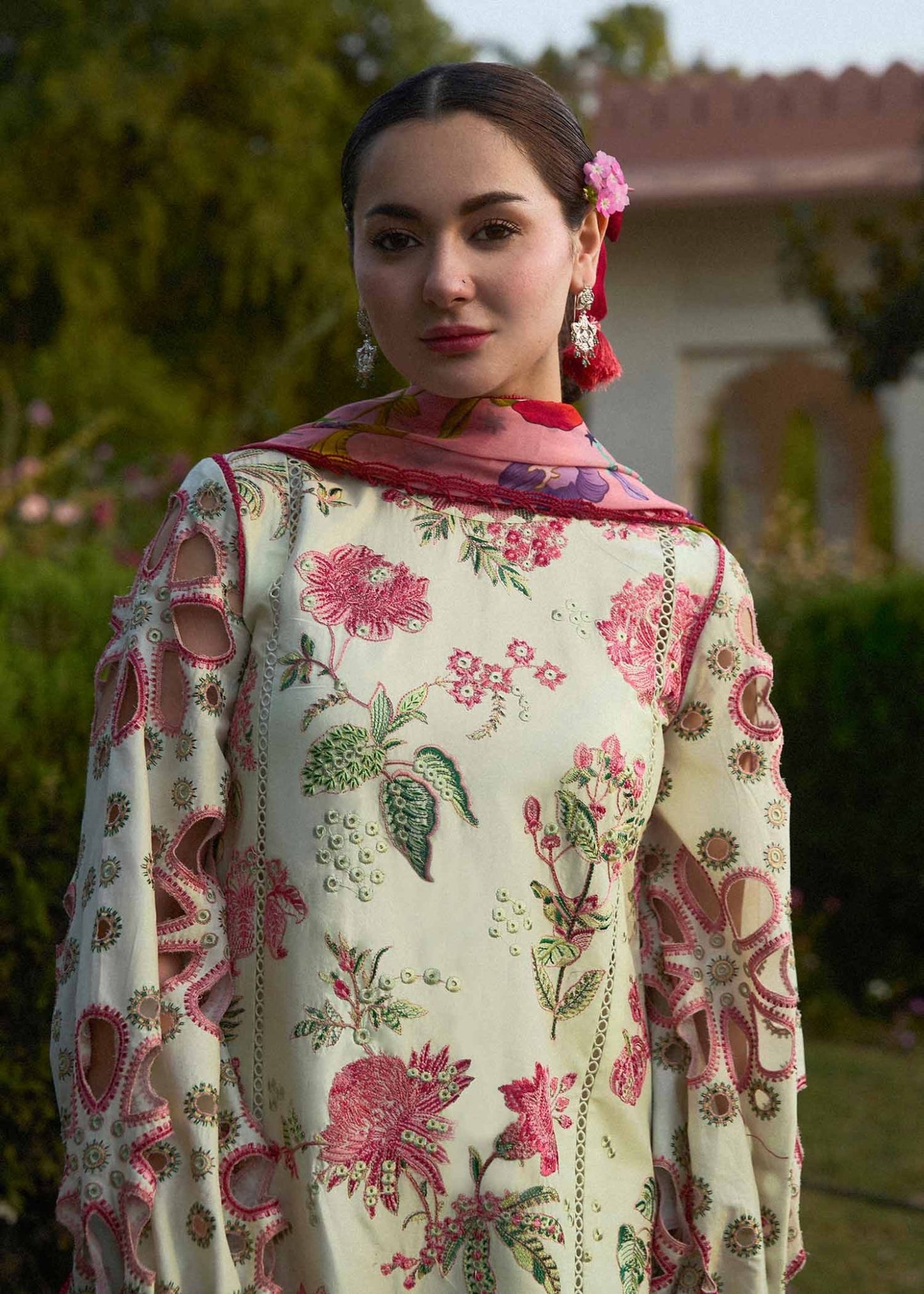 Model wearing a cream Gleam dress with pink floral patterns from Hussain Rehar's SS Lawn 24 collection. Pakistani clothes online in UK.