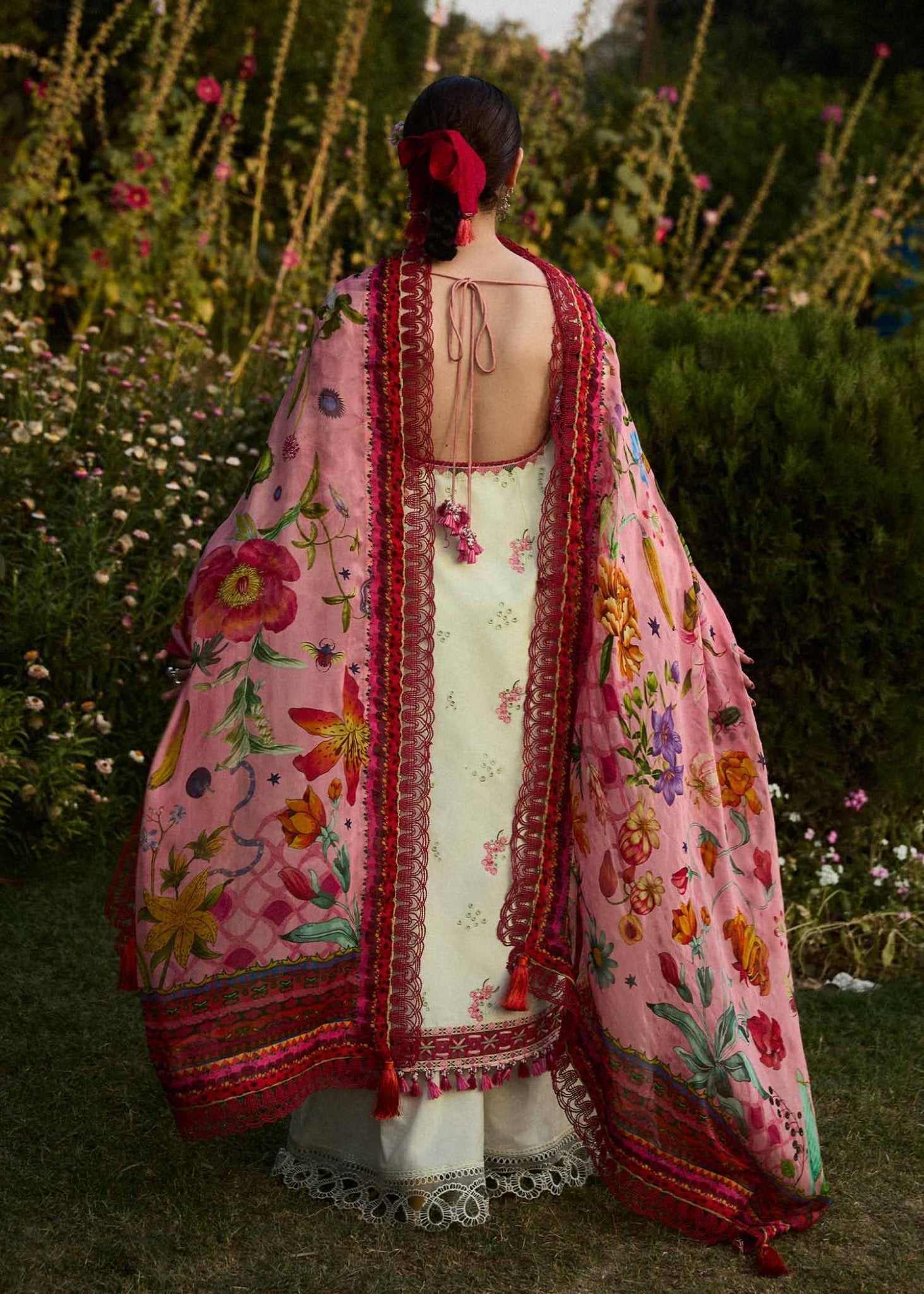 Model wearing a cream Gleam dress with pink floral patterns from Hussain Rehar's SS Lawn 24 collection. Pakistani clothes online in UK.