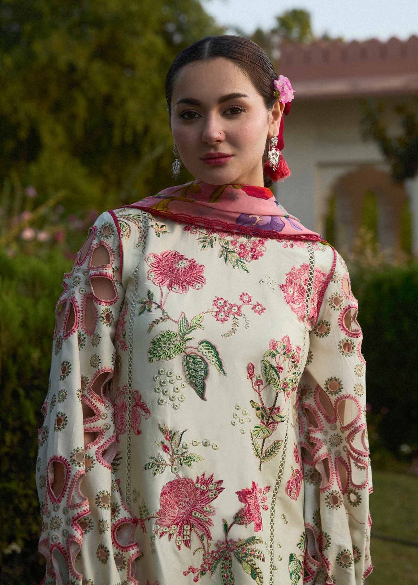 Model wearing a cream Gleam dress with pink floral patterns from Hussain Rehar's SS Lawn 24 collection. Pakistani clothes online in UK.