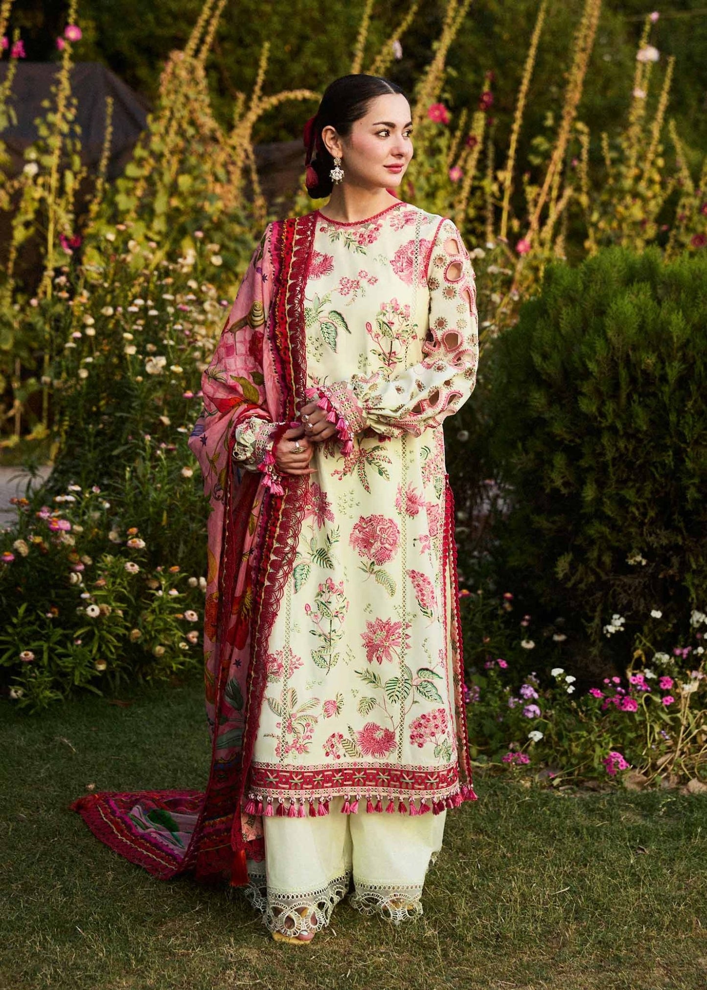 Model wearing a cream Gleam dress with pink floral patterns from Hussain Rehar's SS Lawn 24 collection. Pakistani clothes online in UK.