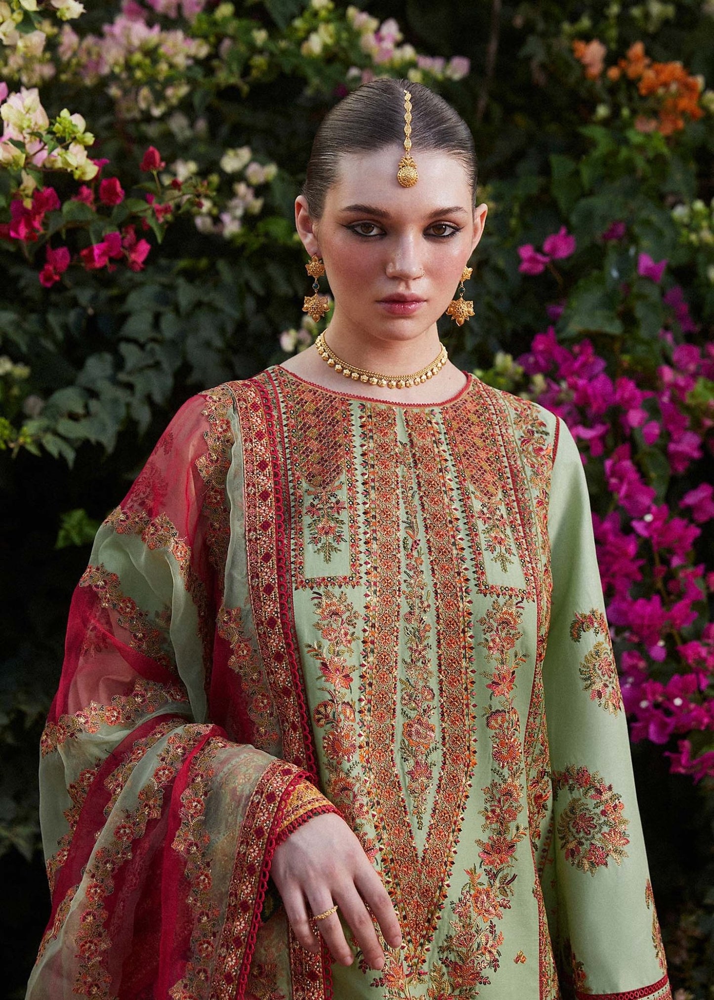 Model wearing light green Gul Bahar dress from Hussain Rehar's Zaiba Lawn '24 collection. Pakistani clothes online in UK. Beautiful floral embroidery.