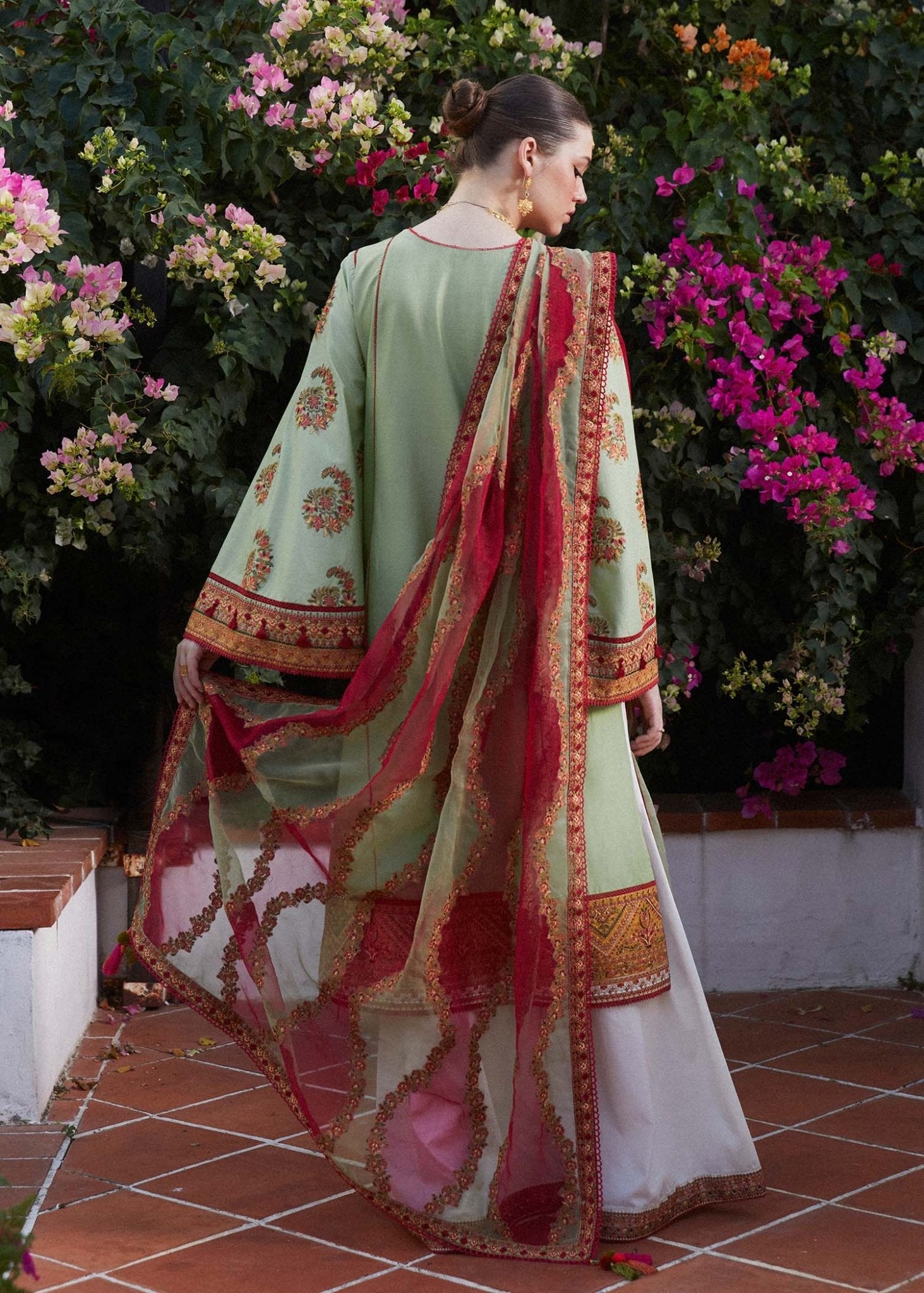 Model wearing light green Gul Bahar dress from Hussain Rehar's Zaiba Lawn '24 collection. Pakistani clothes online in UK. Beautiful floral embroidery.