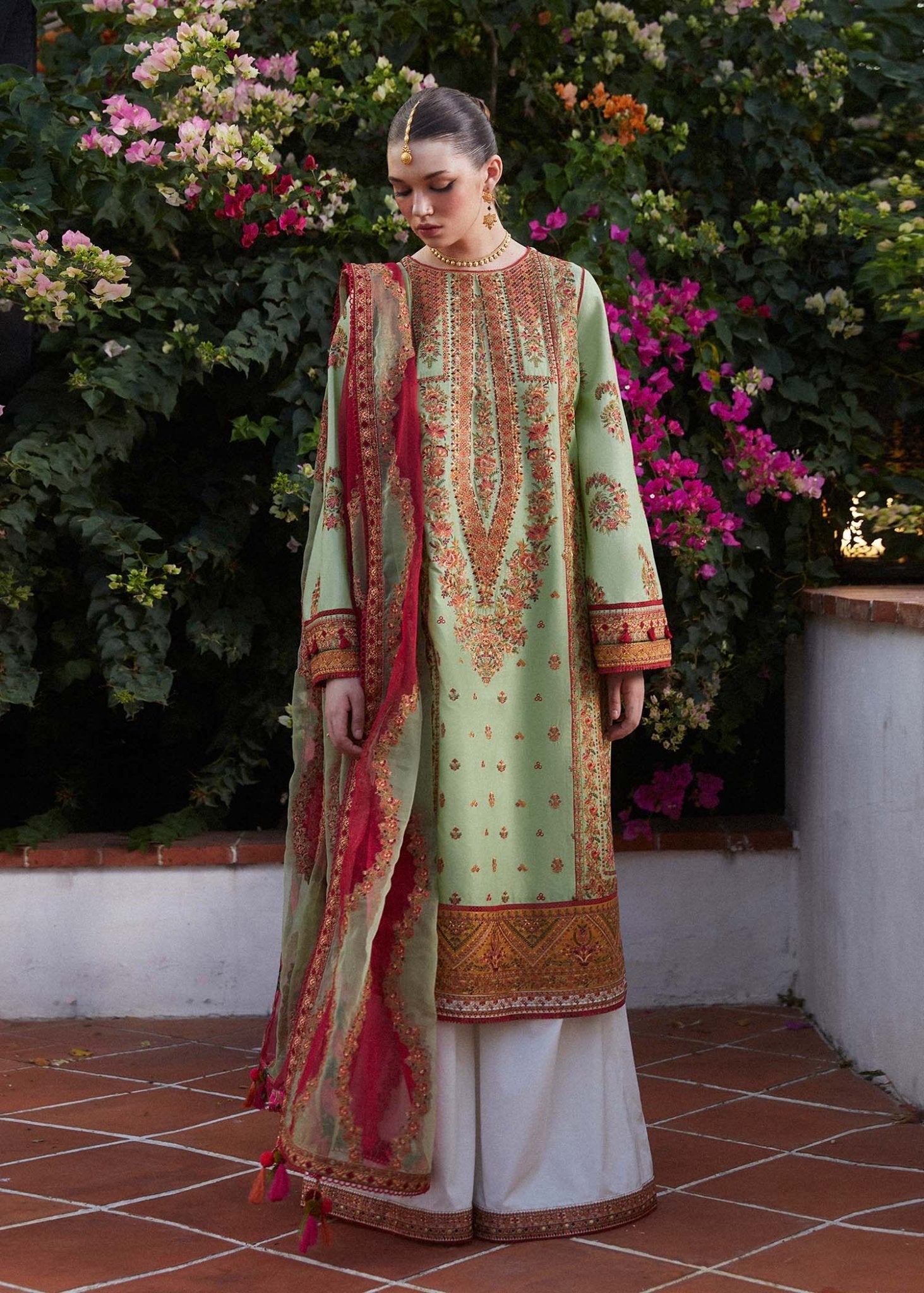 Model wearing light green Gul Bahar dress from Hussain Rehar's Zaiba Lawn '24 collection. Pakistani clothes online in UK. Beautiful floral embroidery.