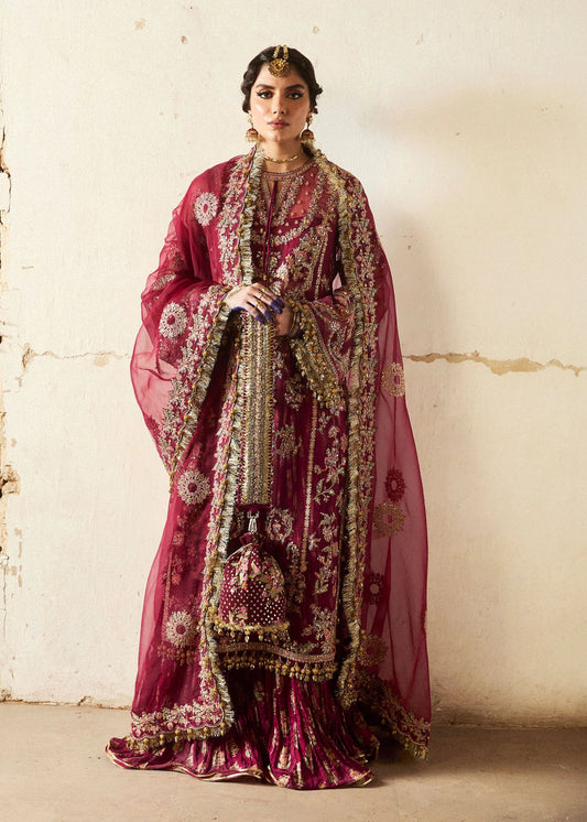 Model wearing a deep maroon Aabni dress from Hussain Rehar's Wedding Festive Sep '24 Collection, featuring intricate gold embellishments. Pakistani wedding clothes available online in the UK.