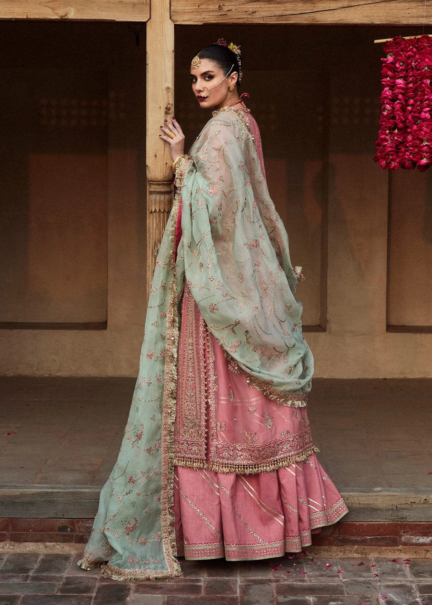 Model wearing a pink and mint green Aadoo dress from Hussain Rehar's Wedding Festive Sep '24 Collection, featuring intricate embroidery and embellishments. Pakistani wedding clothes available online in the UK.