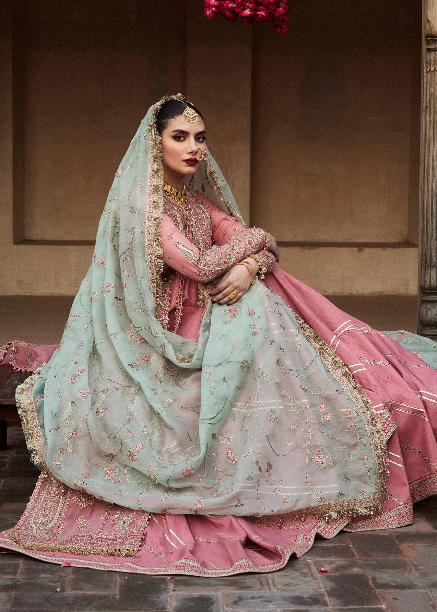 Model wearing a pink and mint green Aadoo dress from Hussain Rehar's Wedding Festive Sep '24 Collection, featuring intricate embroidery and embellishments. Pakistani wedding clothes available online in the UK.