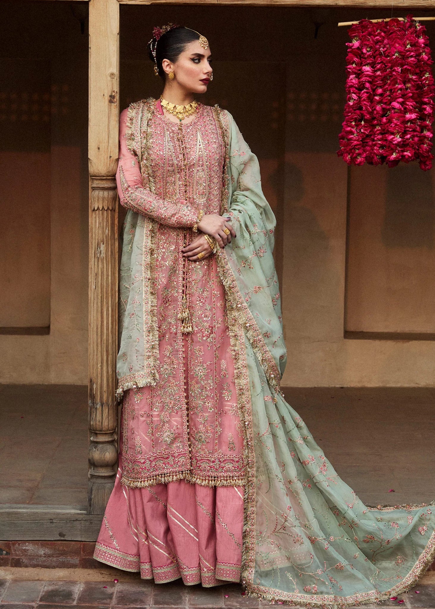 Model wearing a pink and mint green Aadoo dress from Hussain Rehar's Wedding Festive Sep '24 Collection, featuring intricate embroidery and embellishments. Pakistani wedding clothes available online in the UK.