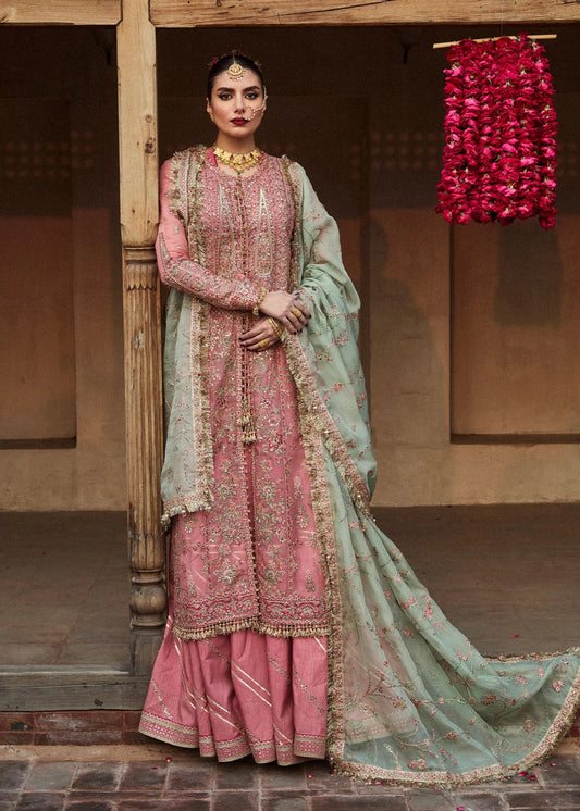 Model wearing a pink and mint green Aadoo dress from Hussain Rehar's Wedding Festive Sep '24 Collection, featuring intricate embroidery and embellishments. Pakistani wedding clothes available online in the UK.