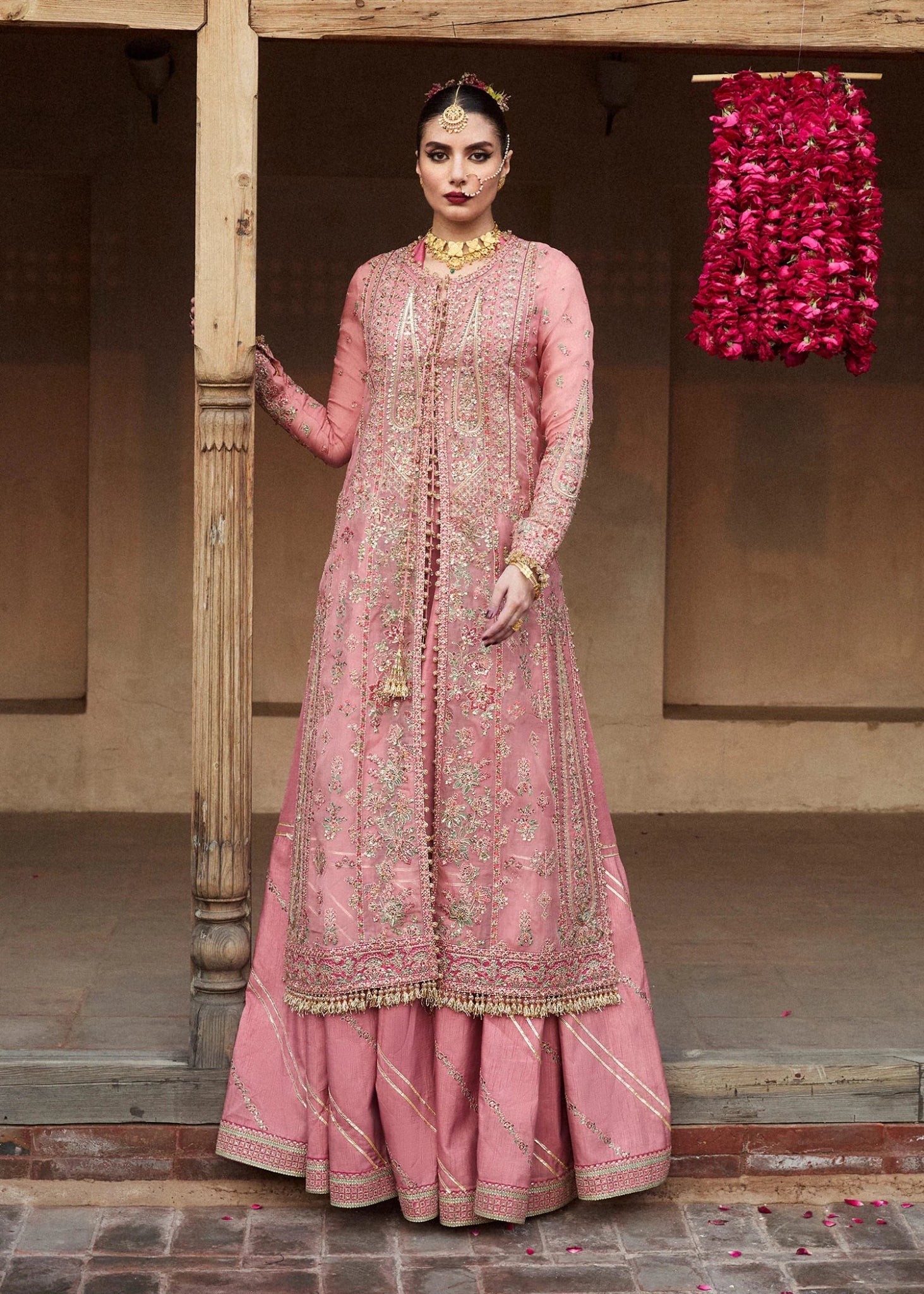 Model wearing a pink and mint green Aadoo dress from Hussain Rehar's Wedding Festive Sep '24 Collection, featuring intricate embroidery and embellishments. Pakistani wedding clothes available online in the UK.