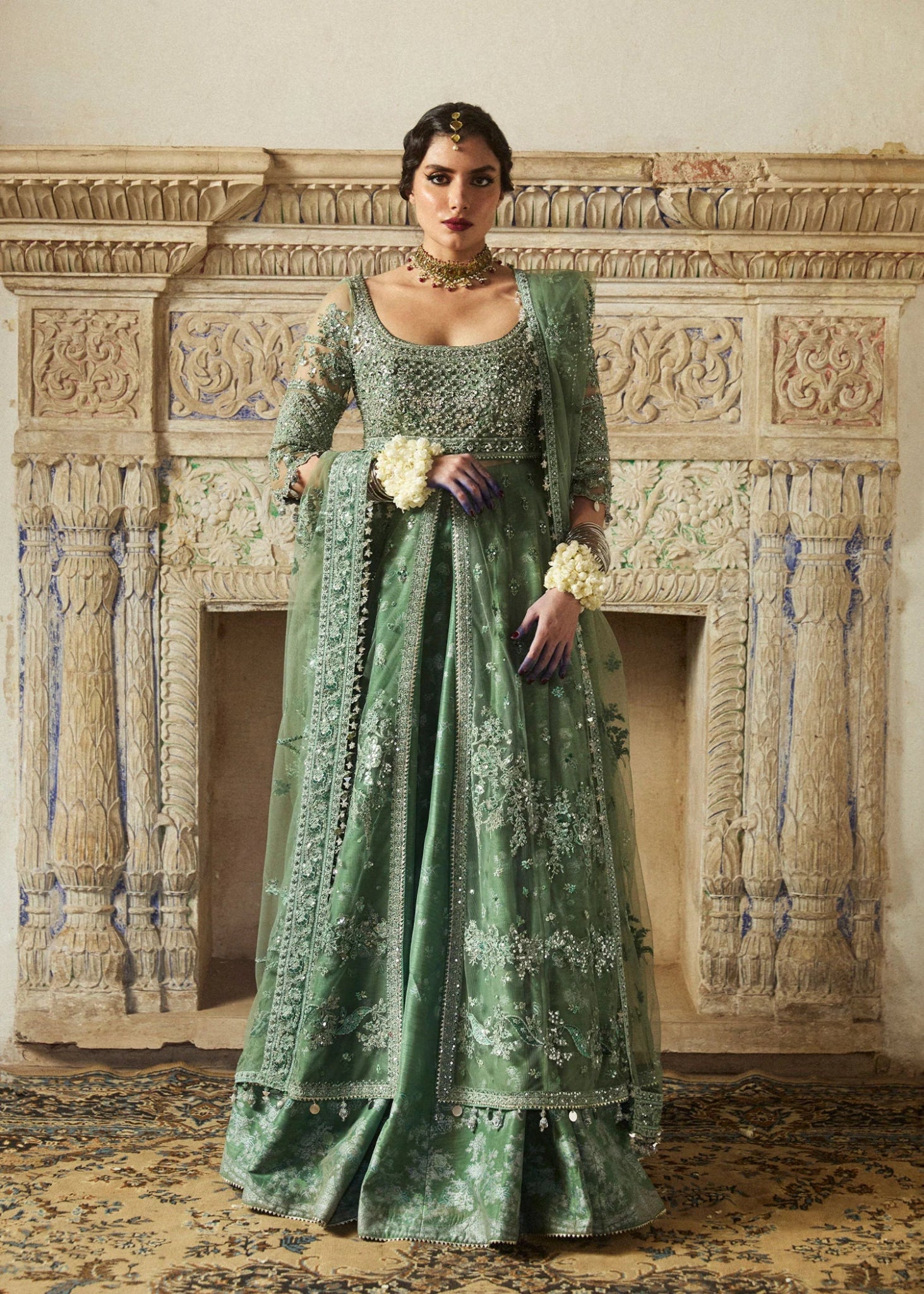 Model wearing a sage green Parag dress from Hussain Rehar's Wedding Festive Sep '24 Collection, featuring intricate embellishments. Pakistani wedding clothes available online in the UK.