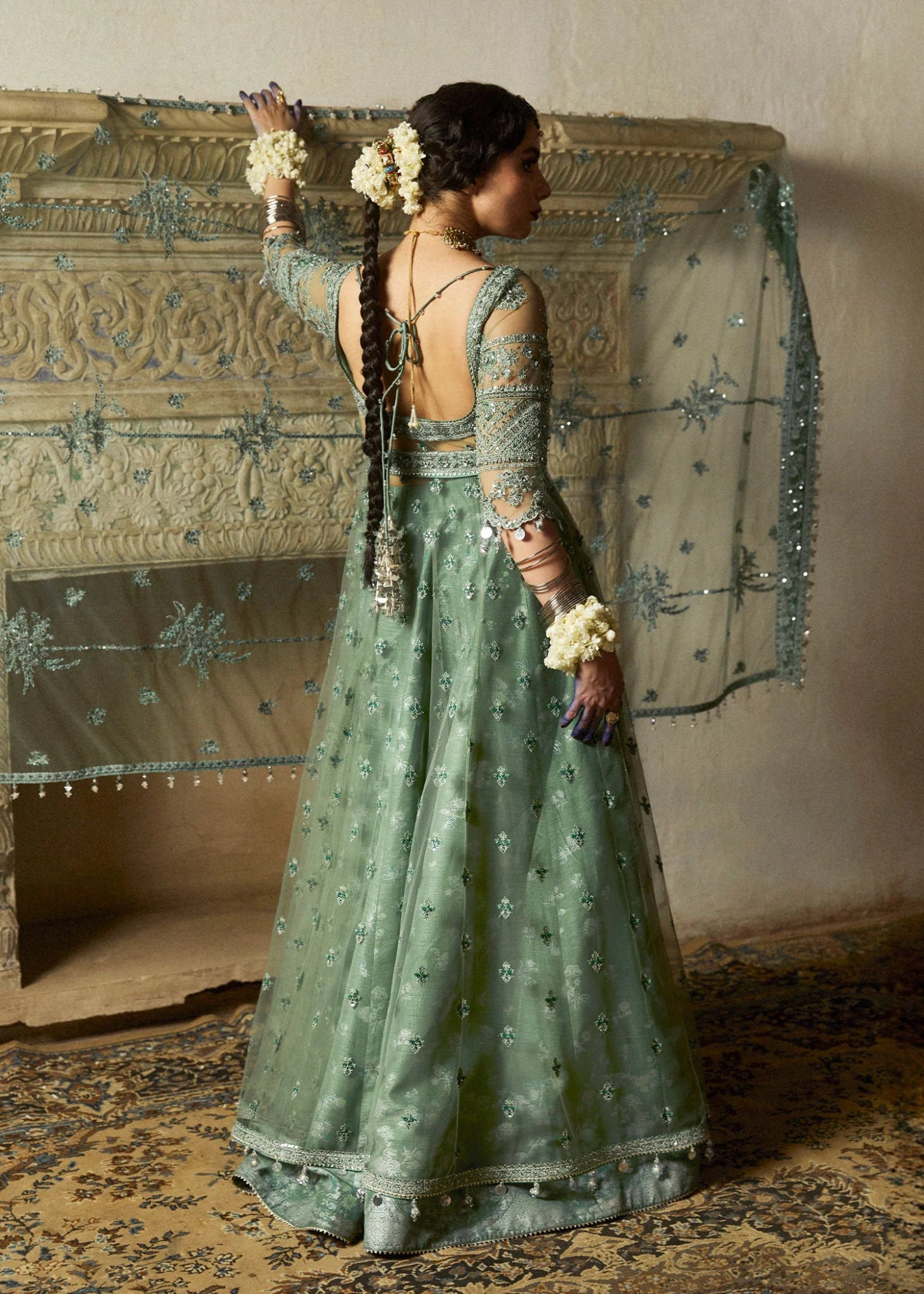 Model wearing a sage green Parag dress from Hussain Rehar's Wedding Festive Sep '24 Collection, featuring intricate embellishments. Pakistani wedding clothes available online in the UK.