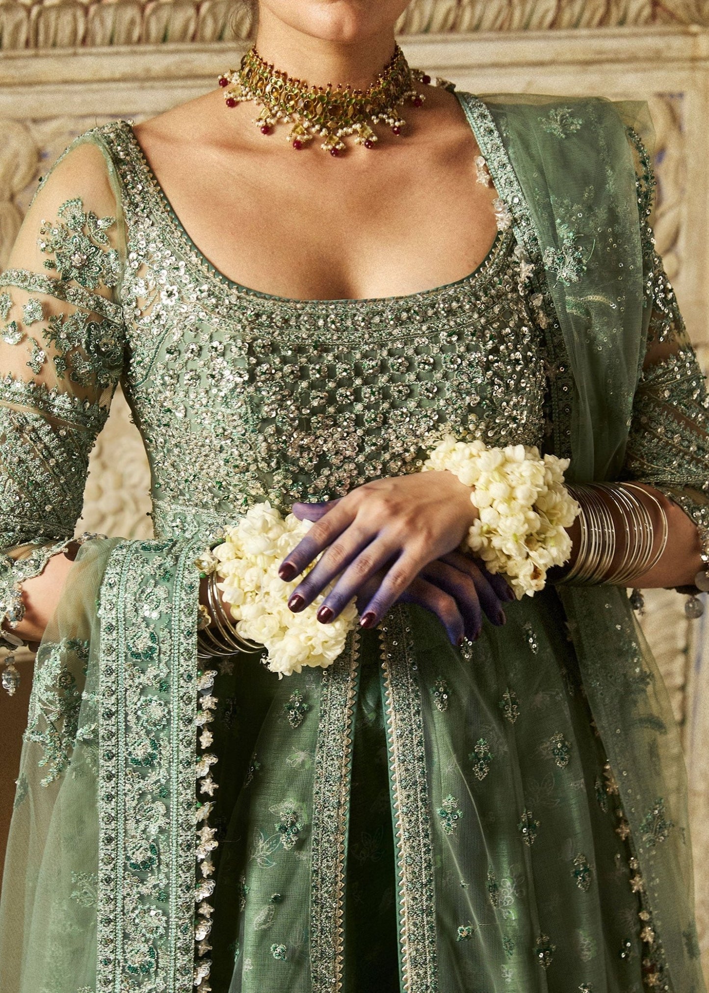 Model wearing a sage green Parag dress from Hussain Rehar's Wedding Festive Sep '24 Collection, featuring intricate embellishments. Pakistani wedding clothes available online in the UK.