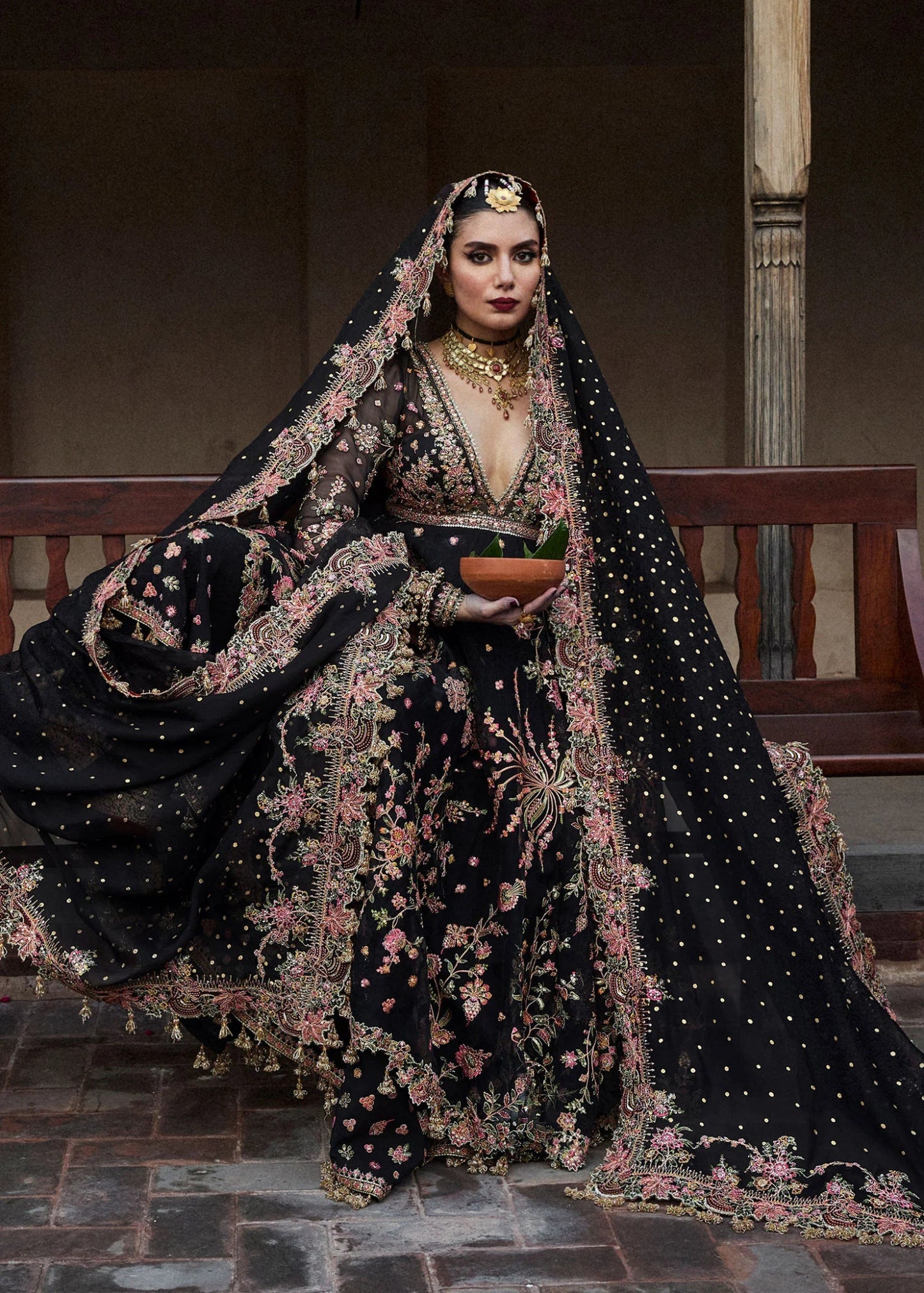 Model wearing a black Pathaar dress from Hussain Rehar's Wedding Festive Sep '24 Collection, featuring intricate floral embroidery. Pakistani wedding clothes available online in the UK.