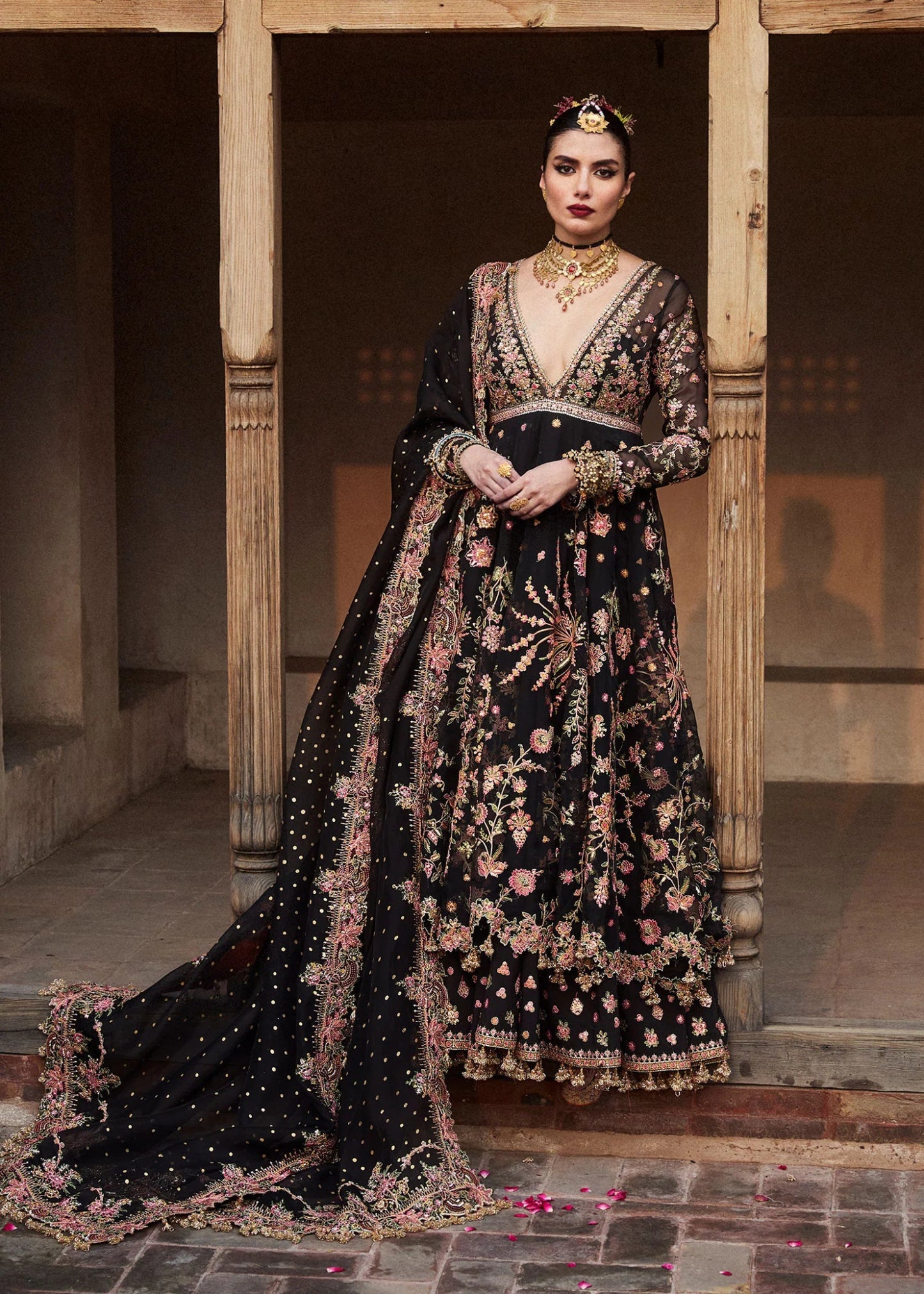 Model wearing a black Pathaar dress from Hussain Rehar's Wedding Festive Sep '24 Collection, featuring intricate floral embroidery. Pakistani wedding clothes available online in the UK.