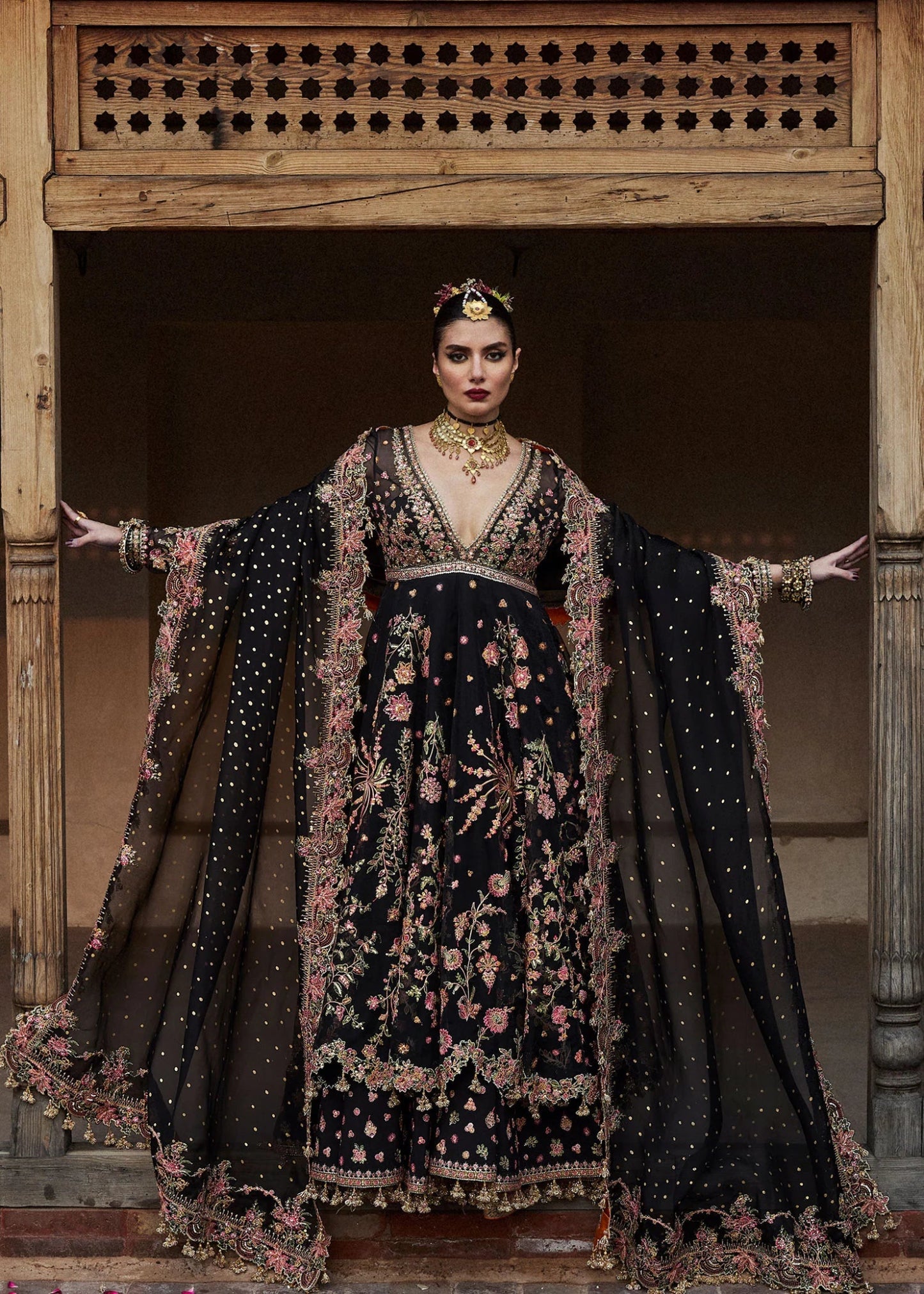 Model wearing a black Pathaar dress from Hussain Rehar's Wedding Festive Sep '24 Collection, featuring intricate floral embroidery. Pakistani wedding clothes available online in the UK.