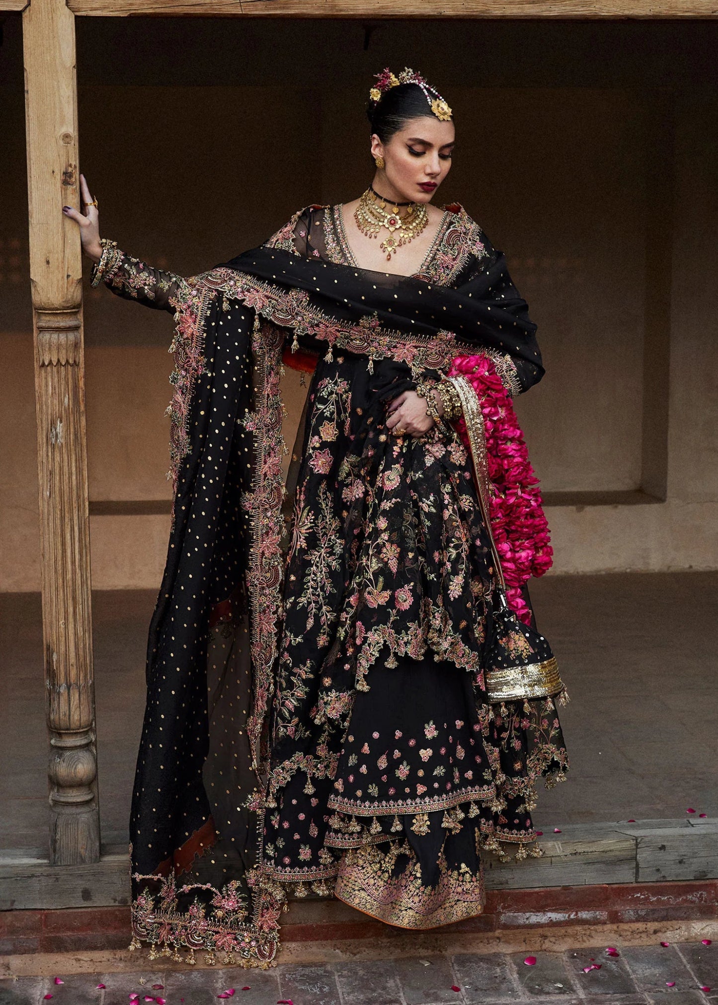 Model wearing a black Pathaar dress from Hussain Rehar's Wedding Festive Sep '24 Collection, featuring intricate floral embroidery. Pakistani wedding clothes available online in the UK.