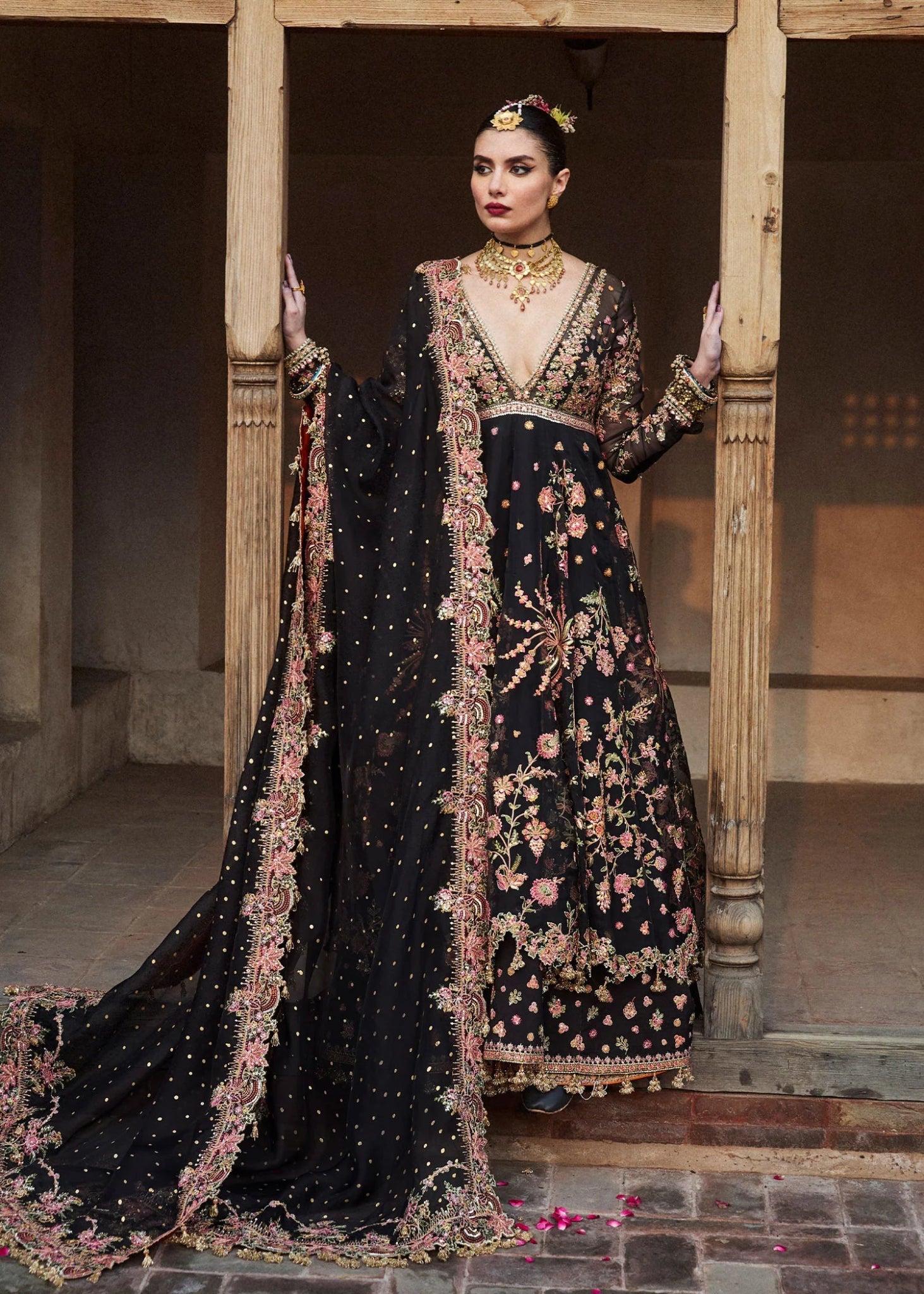 Model wearing a black Pathaar dress from Hussain Rehar's Wedding Festive Sep '24 Collection, featuring intricate floral embroidery. Pakistani wedding clothes available online in the UK.