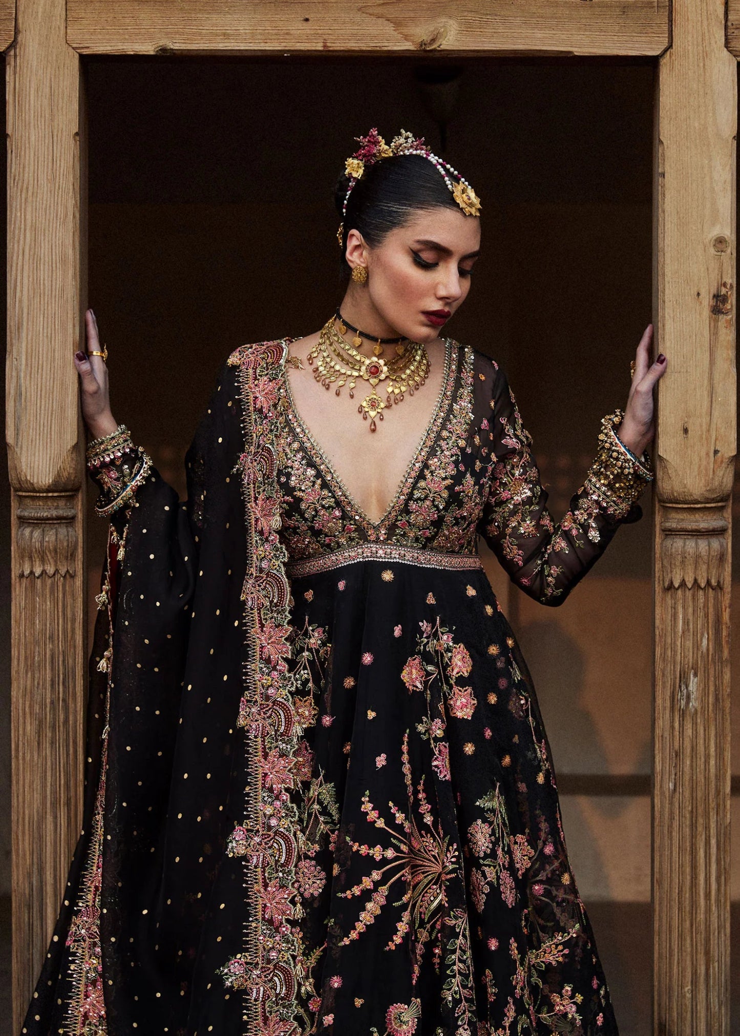 Model wearing a black Pathaar dress from Hussain Rehar's Wedding Festive Sep '24 Collection, featuring intricate floral embroidery. Pakistani wedding clothes available online in the UK.