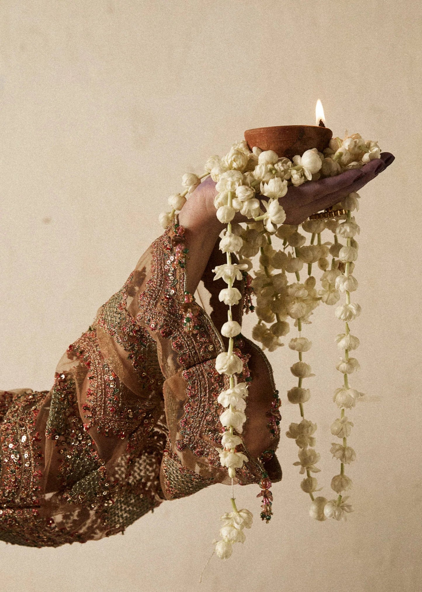 Model wearing a bronze Raitla dress from Hussain Rehar's Wedding Festive Sep '24 Collection, featuring floral embroidery and embellished details. Pakistani wedding clothes available online in the UK.