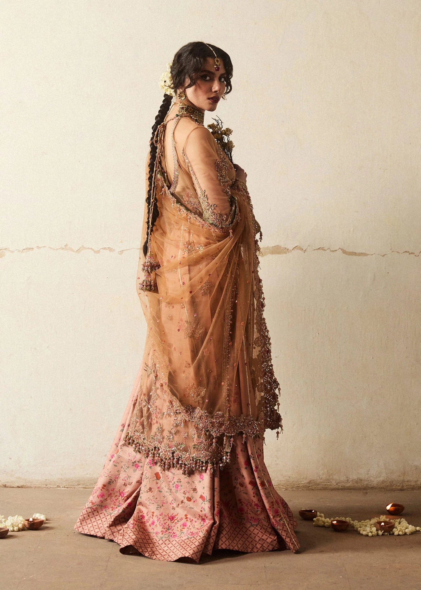 Model wearing a bronze Raitla dress from Hussain Rehar's Wedding Festive Sep '24 Collection, featuring floral embroidery and embellished details. Pakistani wedding clothes available online in the UK.