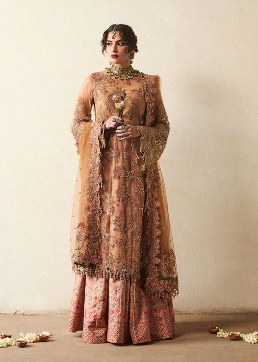 Model wearing a bronze Raitla dress from Hussain Rehar's Wedding Festive Sep '24 Collection, featuring floral embroidery and embellished details. Pakistani wedding clothes available online in the UK.