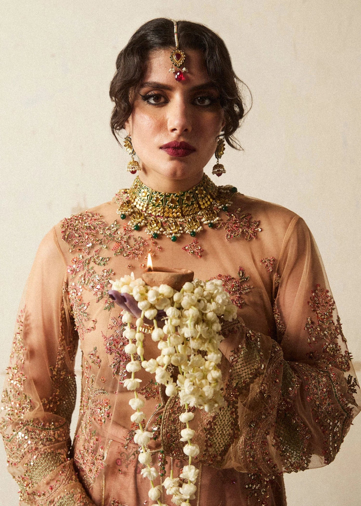 Model wearing a bronze Raitla dress from Hussain Rehar's Wedding Festive Sep '24 Collection, featuring floral embroidery and embellished details. Pakistani wedding clothes available online in the UK.