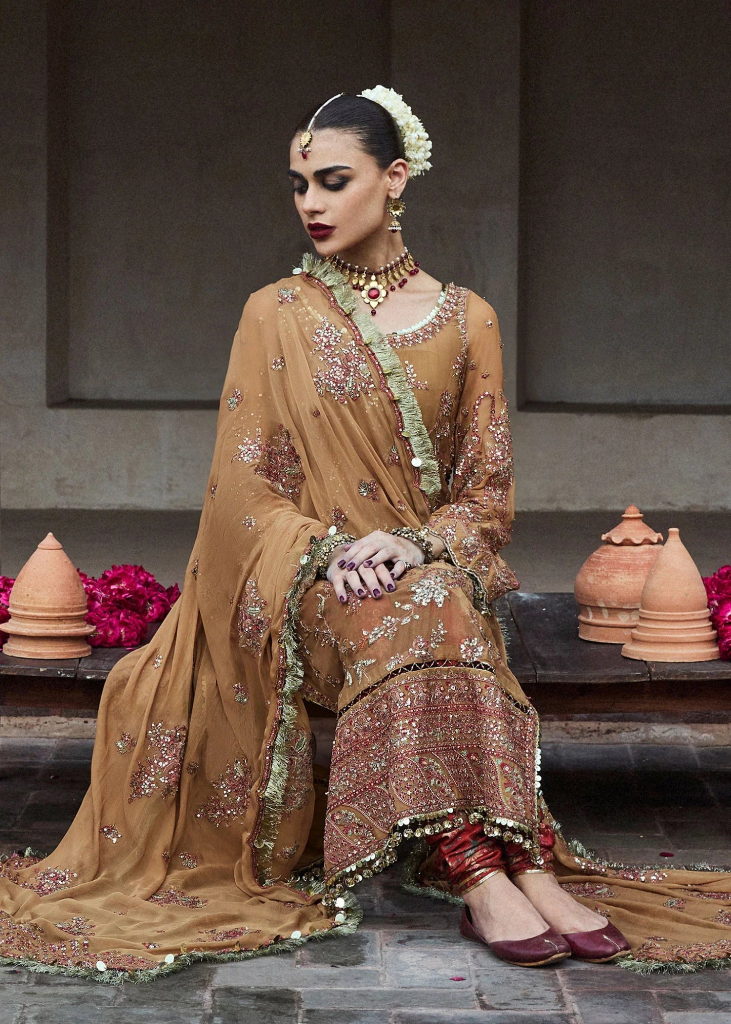 Model wearing a mustard - colored Talai dress from Hussain Rehar's Wedding Festive Sep '24 Collection, featuring intricate embroidery and embellishments. Pakistani wedding clothes available online in the UK.