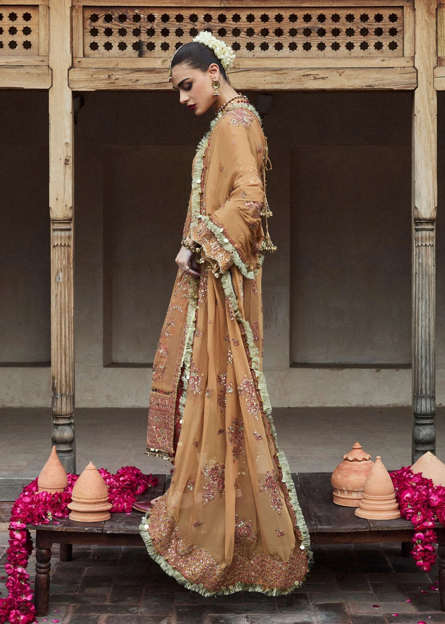 Model wearing a mustard - colored Talai dress from Hussain Rehar's Wedding Festive Sep '24 Collection, featuring intricate embroidery and embellishments. Pakistani wedding clothes available online in the UK.