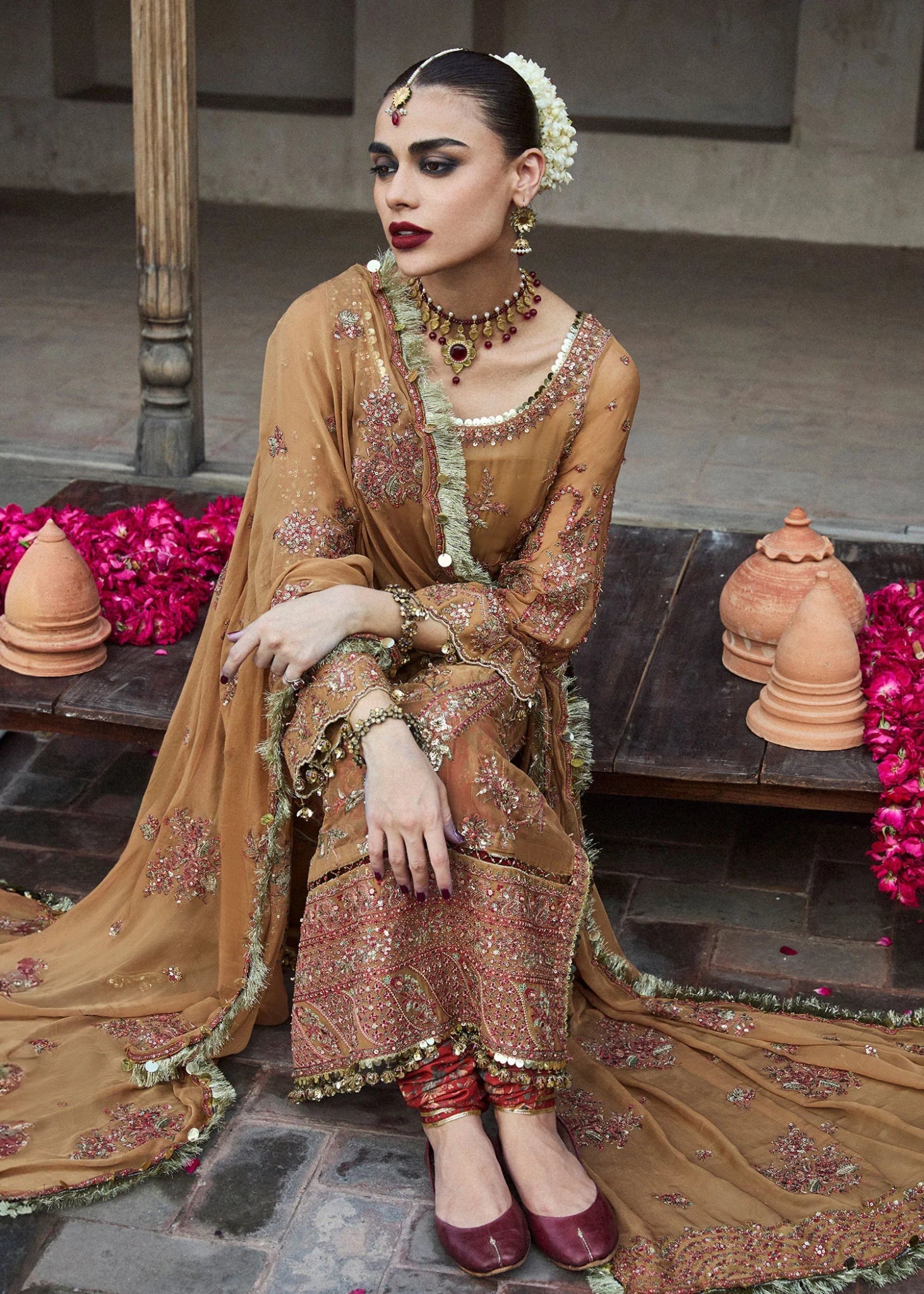 Model wearing a mustard - colored Talai dress from Hussain Rehar's Wedding Festive Sep '24 Collection, featuring intricate embroidery and embellishments. Pakistani wedding clothes available online in the UK.