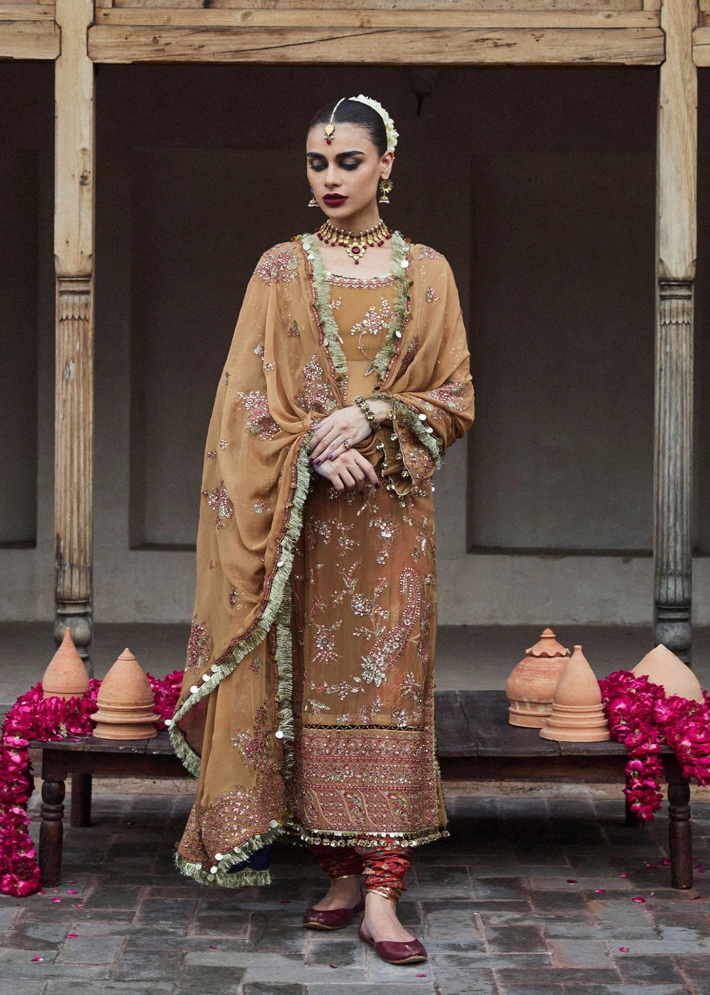 Model wearing a mustard - colored Talai dress from Hussain Rehar's Wedding Festive Sep '24 Collection, featuring intricate embroidery and embellishments. Pakistani wedding clothes available online in the UK.