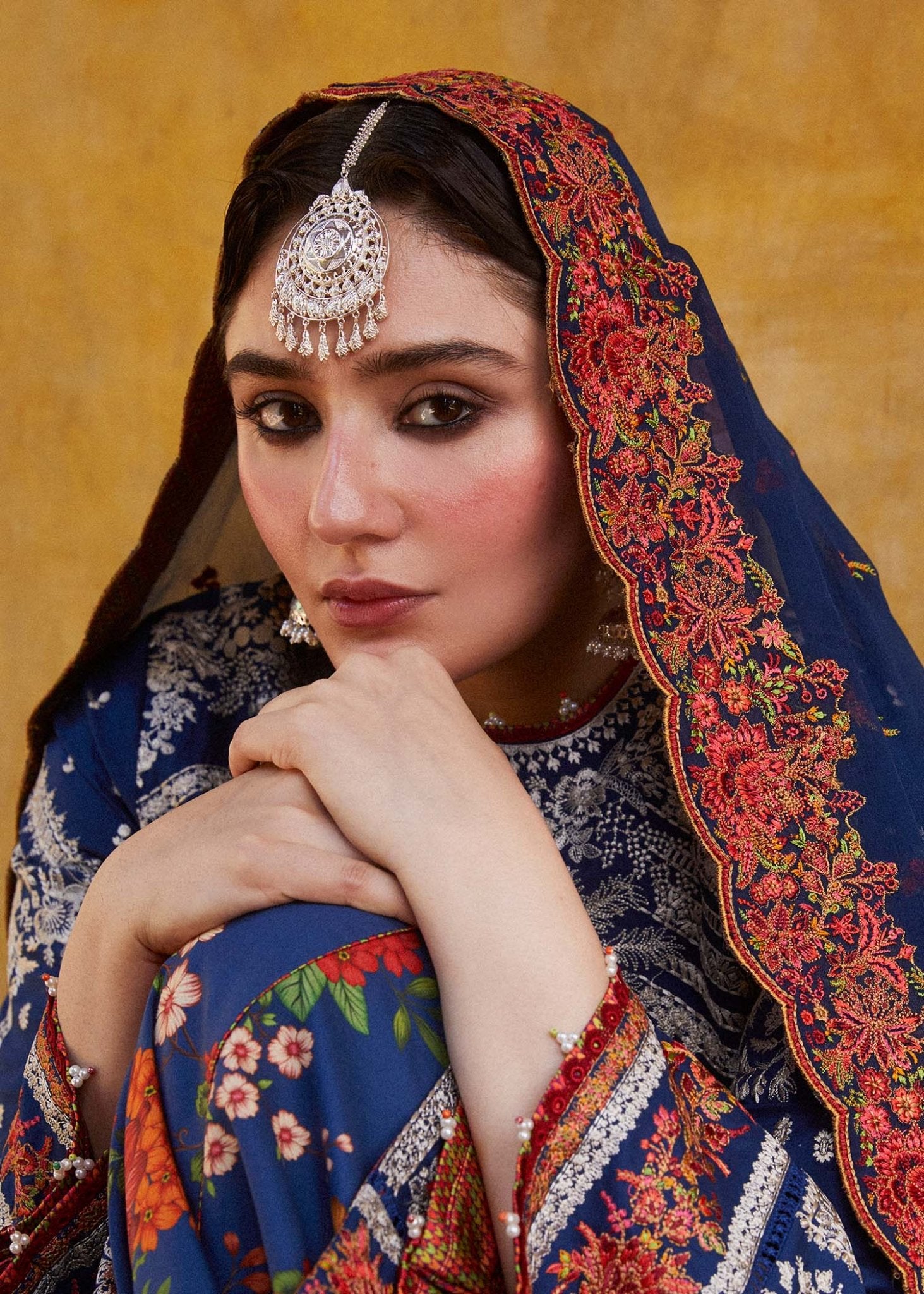 Model wearing blue Neelofar dress from Hussain Rehar's Zaiba Lawn '24 collection. Pakistani clothes online in UK. Detailed floral embroidery.