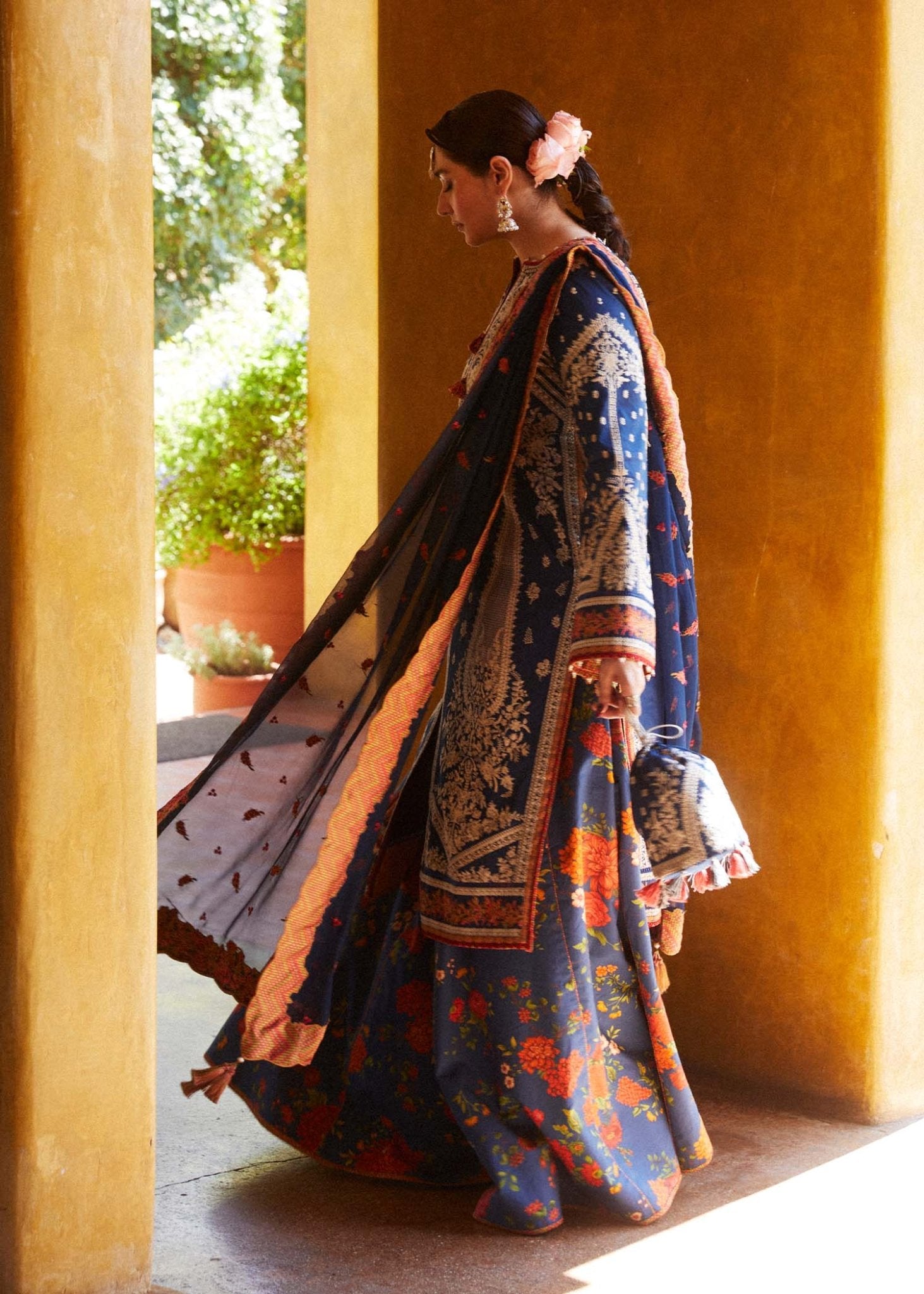 Model wearing blue Neelofar dress from Hussain Rehar's Zaiba Lawn '24 collection. Pakistani clothes online in UK. Detailed floral embroidery.