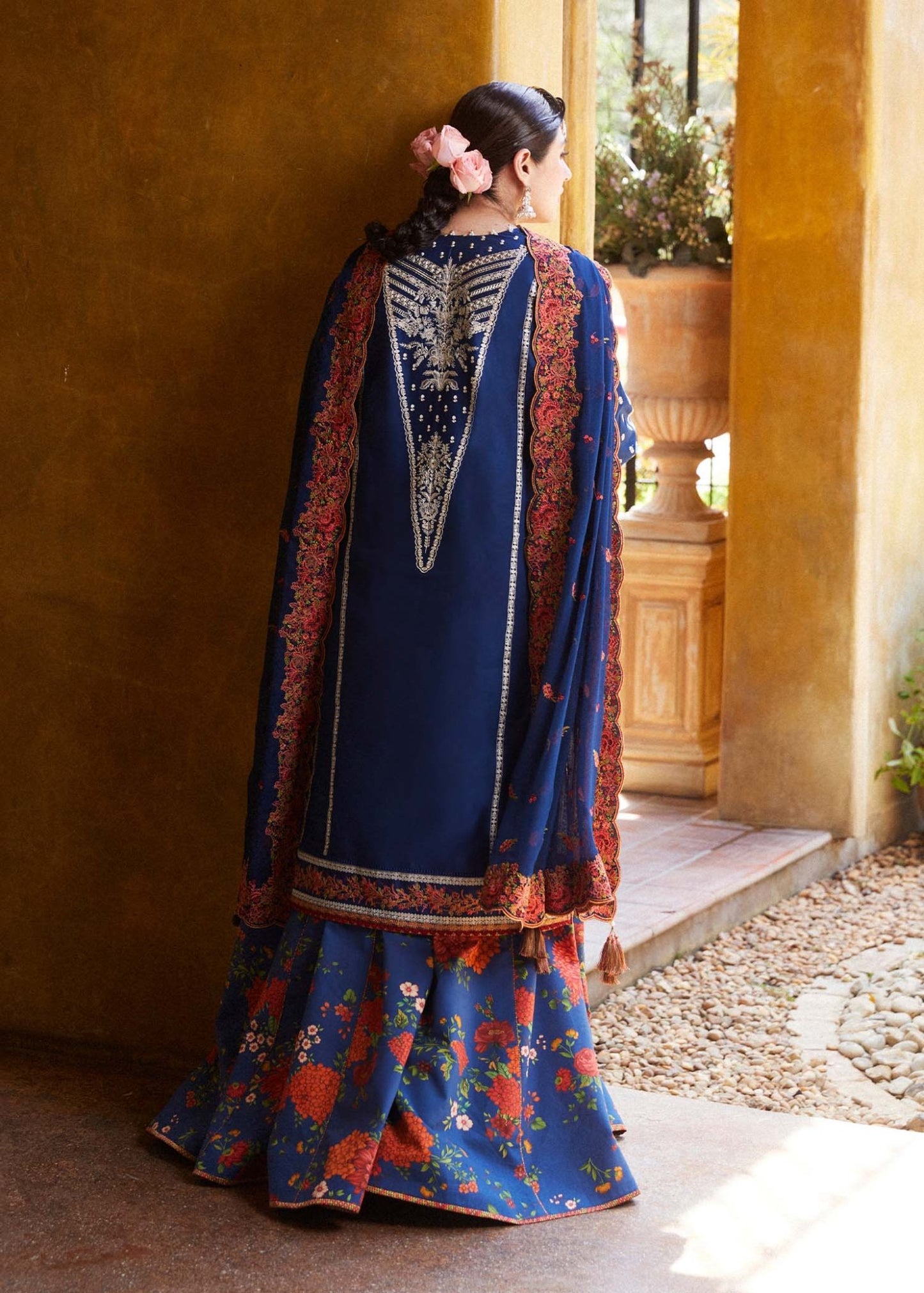 Model wearing blue Neelofar dress from Hussain Rehar's Zaiba Lawn '24 collection. Pakistani clothes online in UK. Detailed floral embroidery.