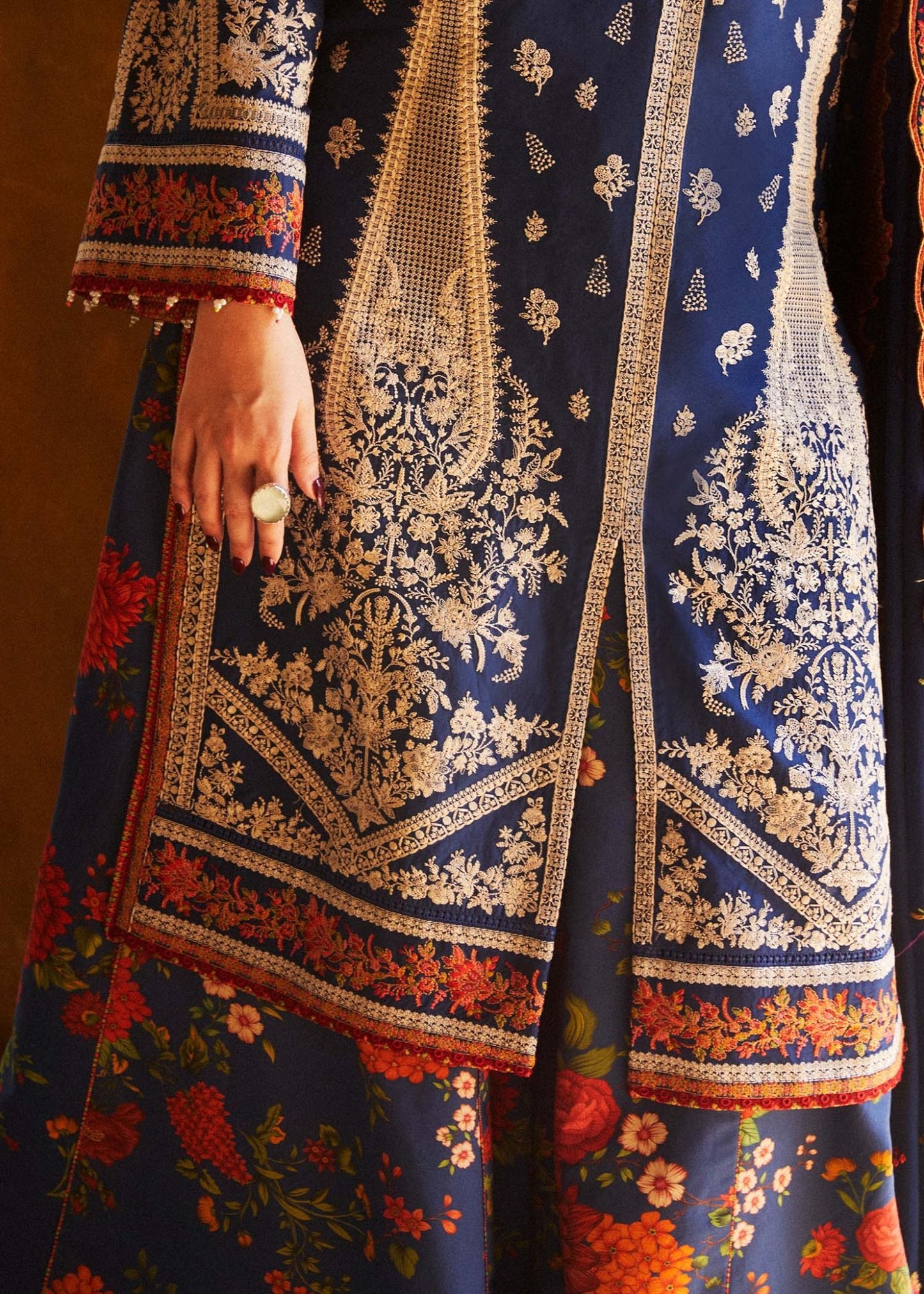 Model wearing blue Neelofar dress from Hussain Rehar's Zaiba Lawn '24 collection. Pakistani clothes online in UK. Detailed floral embroidery.