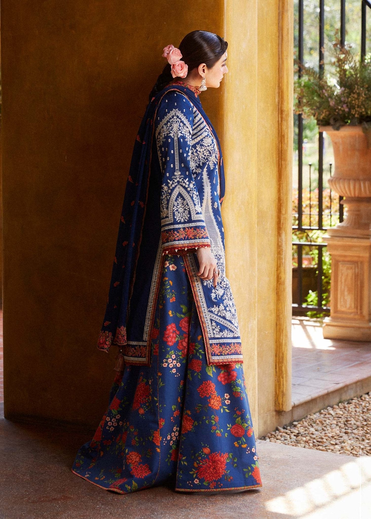 Model wearing blue Neelofar dress from Hussain Rehar's Zaiba Lawn '24 collection. Pakistani clothes online in UK. Detailed floral embroidery.