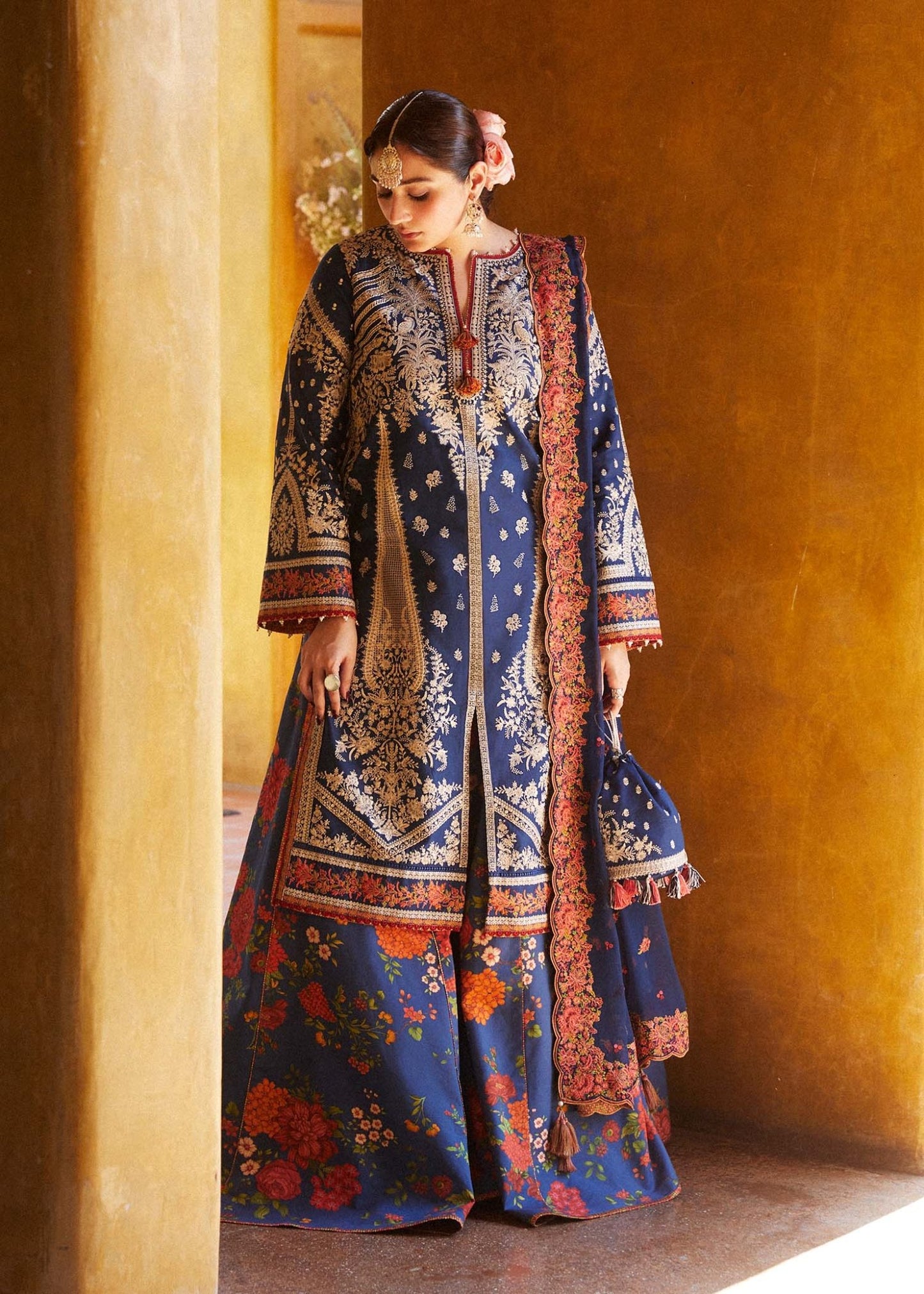 Model in Hussain Rehar Neelofar, navy blue with intricate patterns, elegant Pakistani clothes UK.